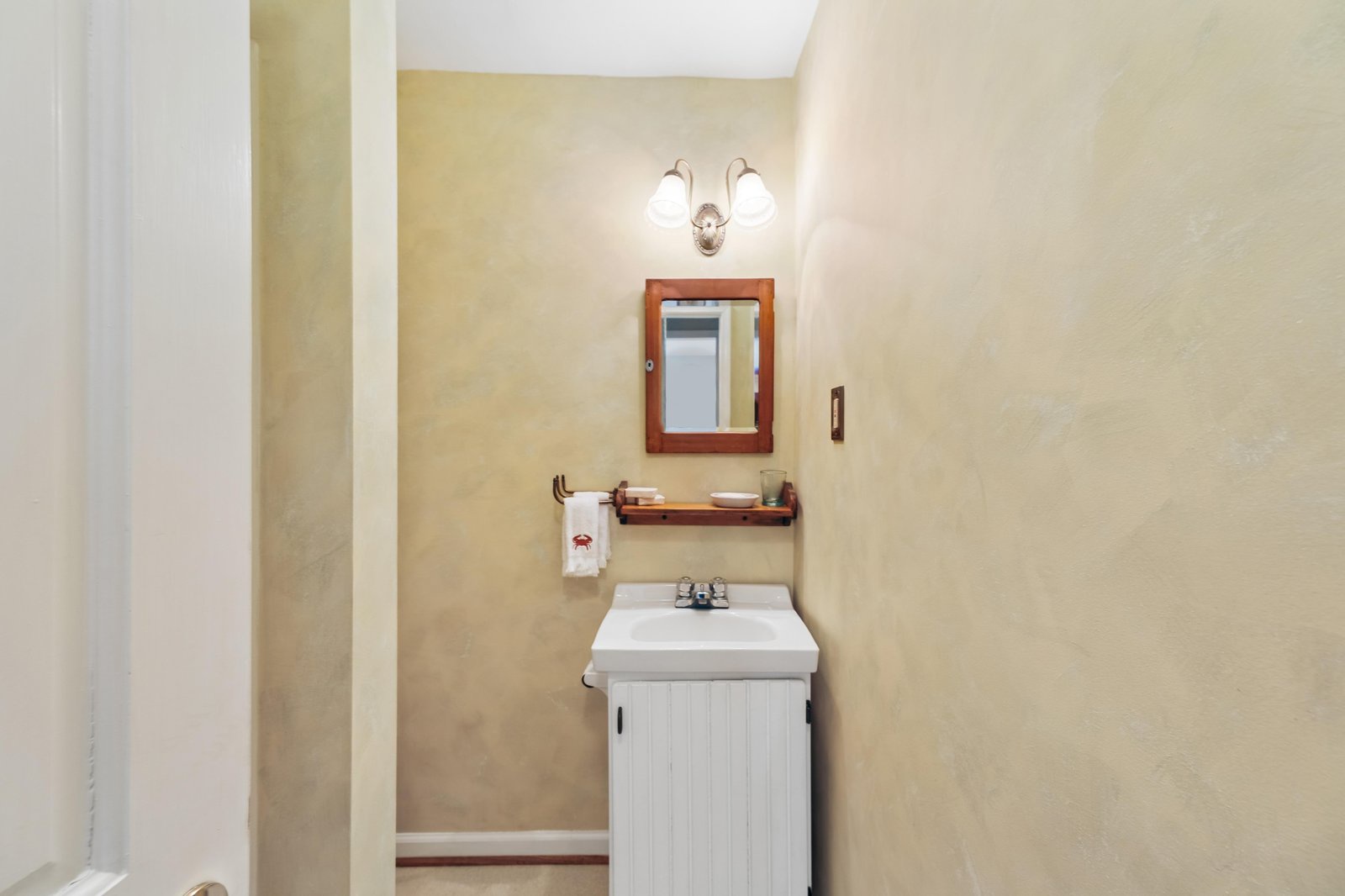 Your private vanity features warm wood accents and soft lighting that creates a welcoming, home-like feel every time you freshen up.