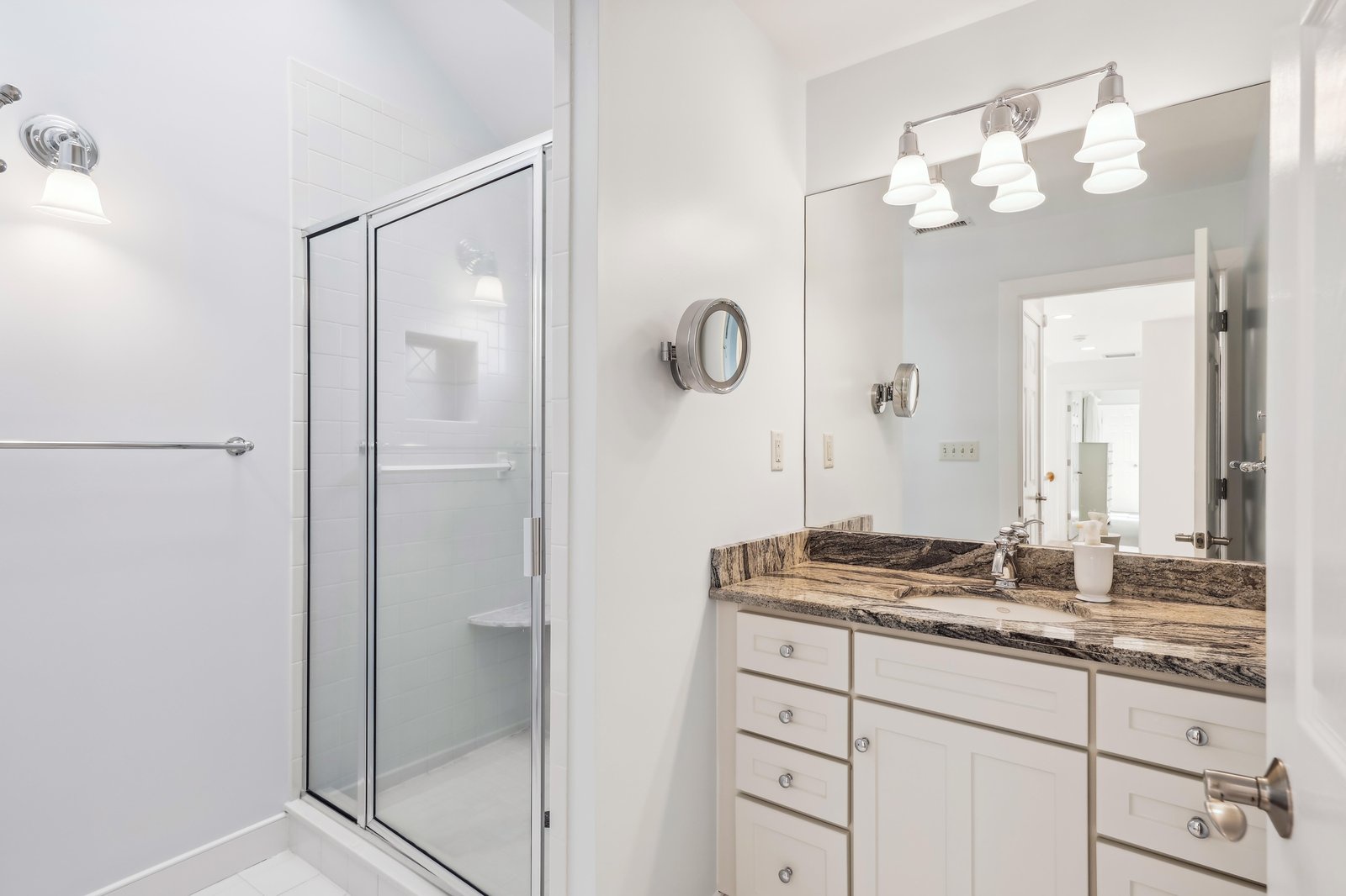 Your private bathroom offers a sparkling glass-enclosed shower, elegant granite countertops, and a large vanity with ample storage—perfect for unwinding after a day of adventure.