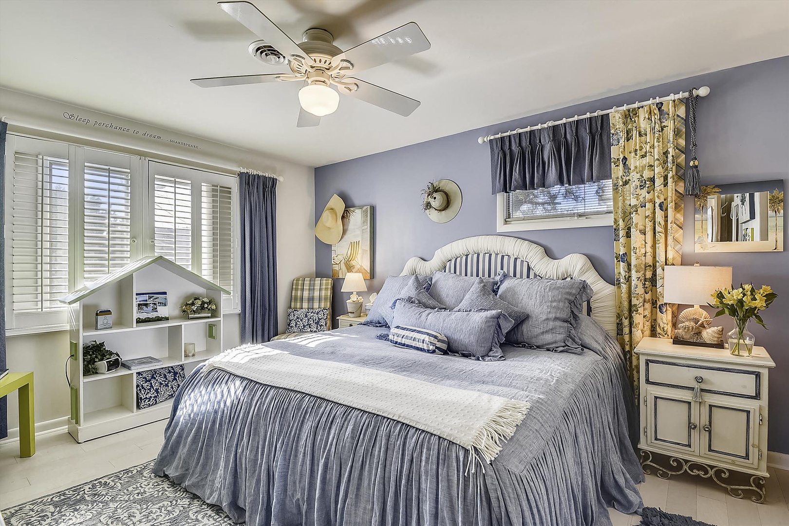 Step into your peaceful retreat with a plush bed draped in soft linens, gentle ceiling fan overhead, and warm morning light streaming through the windows.