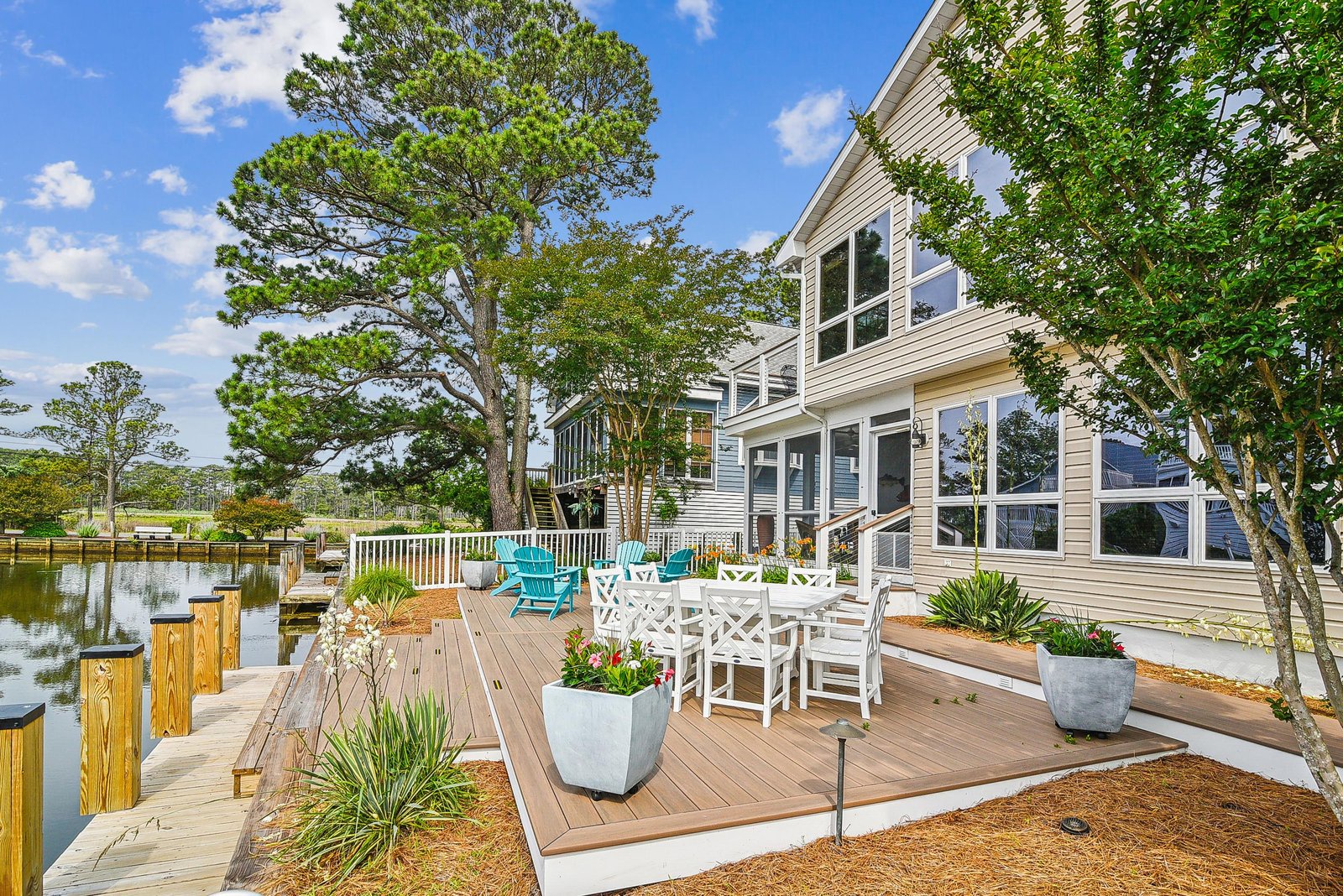 A waterfront retreat with your own private dock and spacious deck for outdoor dining. Enjoy peaceful canal views surrounded by lush greenery from this inviting outdoor space.