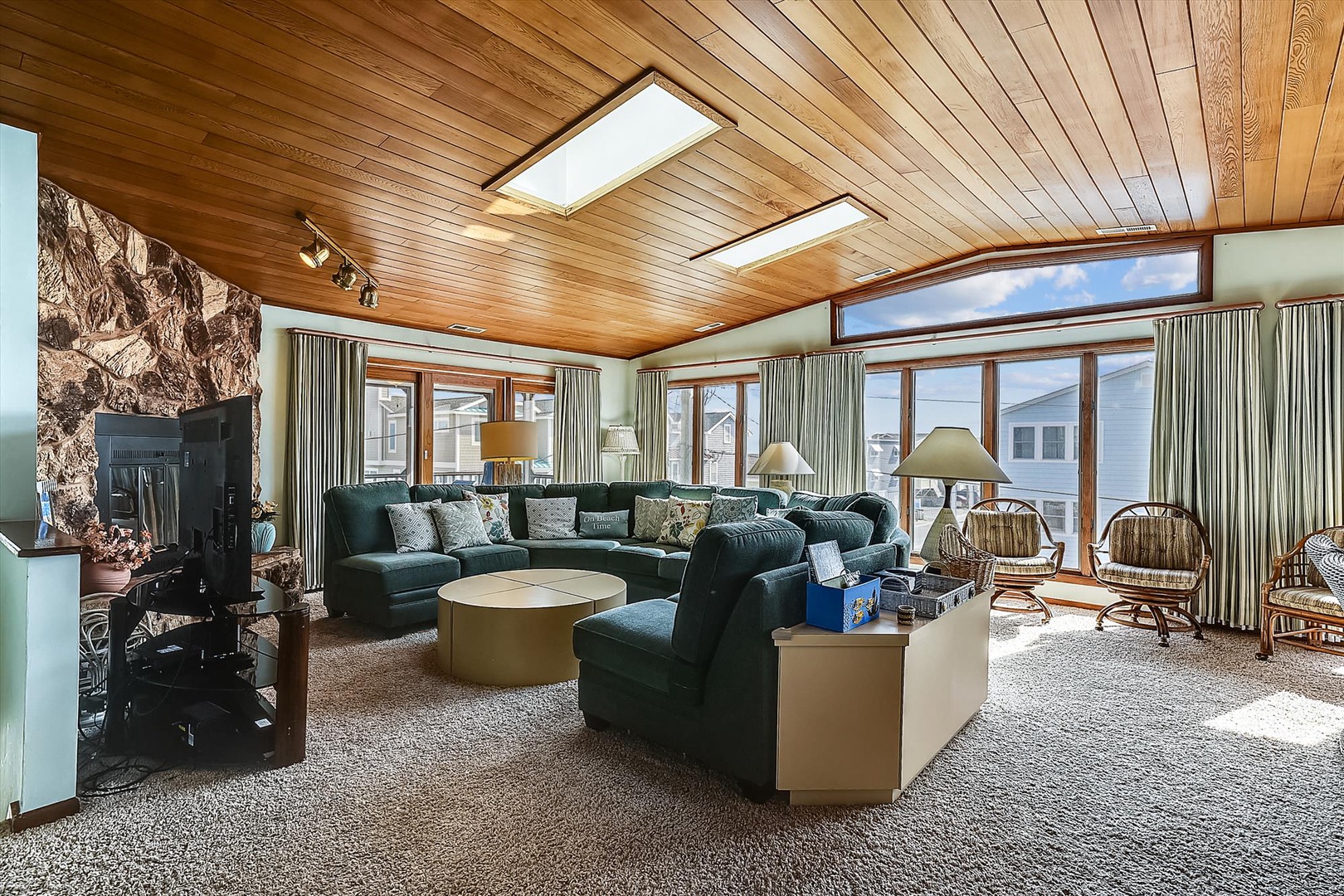 Sink into plush seating beneath warm wood ceilings and skylights that fill your living space with natural light. Large windows frame mountain views while a cozy fireplace adds alpine charm.