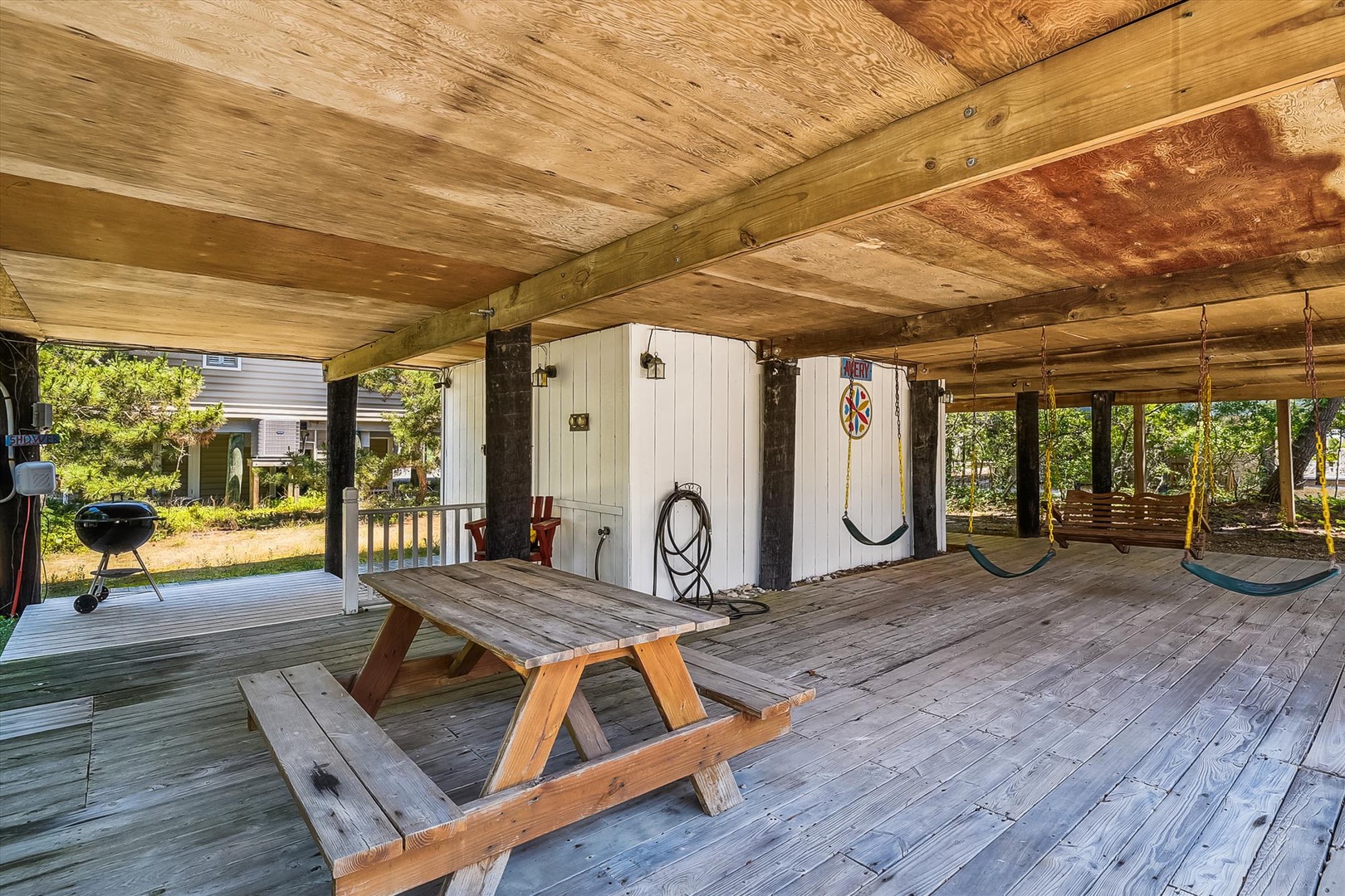 Relax in your private covered outdoor space with a picnic table, grill, and hammock swings—perfect for alfresco dining and lazy afternoons in the fresh air.