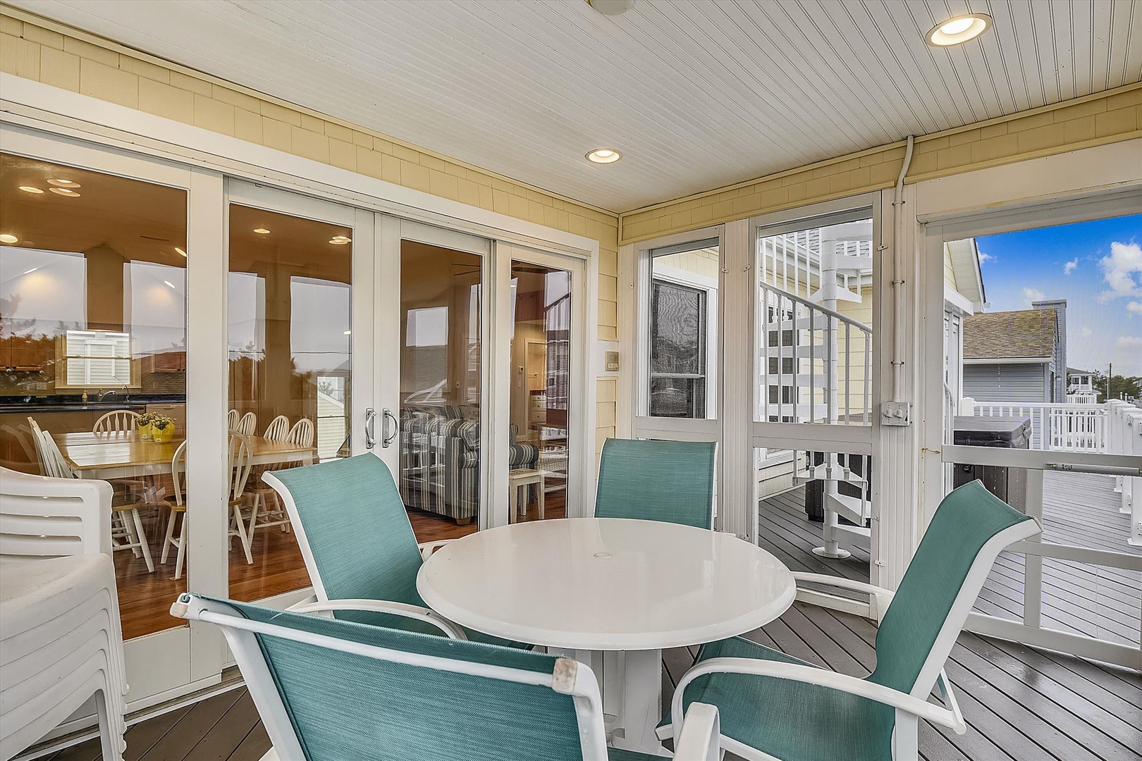 Enjoy morning coffee or evening cocktails on your private screened balcony, featuring cozy outdoor dining and breezy coastal views. Your perfect retreat awaits.