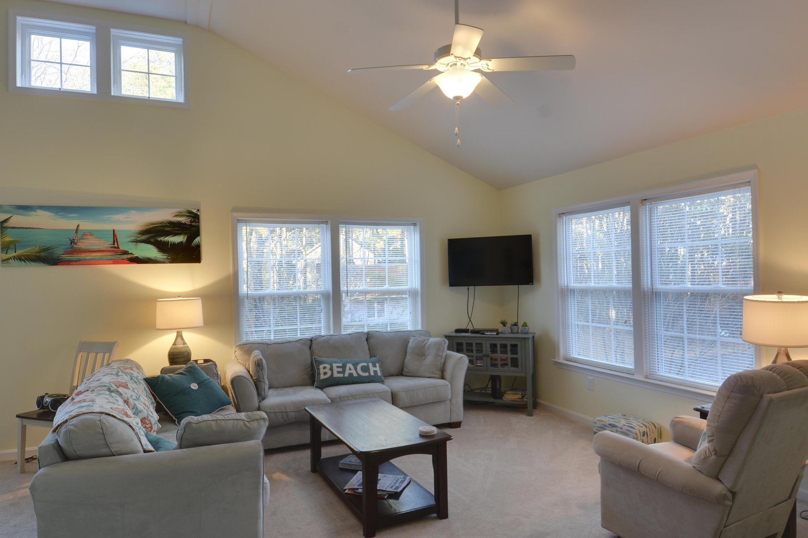 Relax in your spacious living area with vaulted ceilings, comfortable seating, and plenty of natural light streaming through large windows. Kick back, enjoy the beach-inspired décor, and make yourself at home.