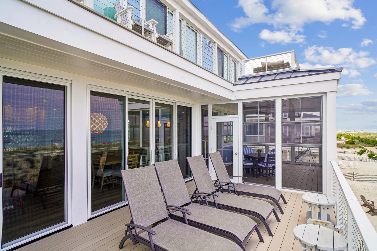 A spacious rooftop deck for your ultimate beachside escape. Soak up the sun on lounge chairs, dine al fresco, and enjoy panoramic coastal surroundings with easy access to the interiors below.