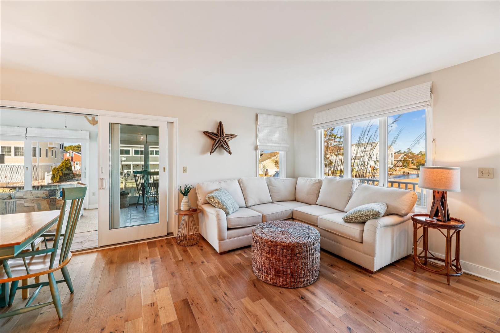 Sink into plush sectional seating while warm hardwood floors and coastal décor create your perfect retreat for relaxation.