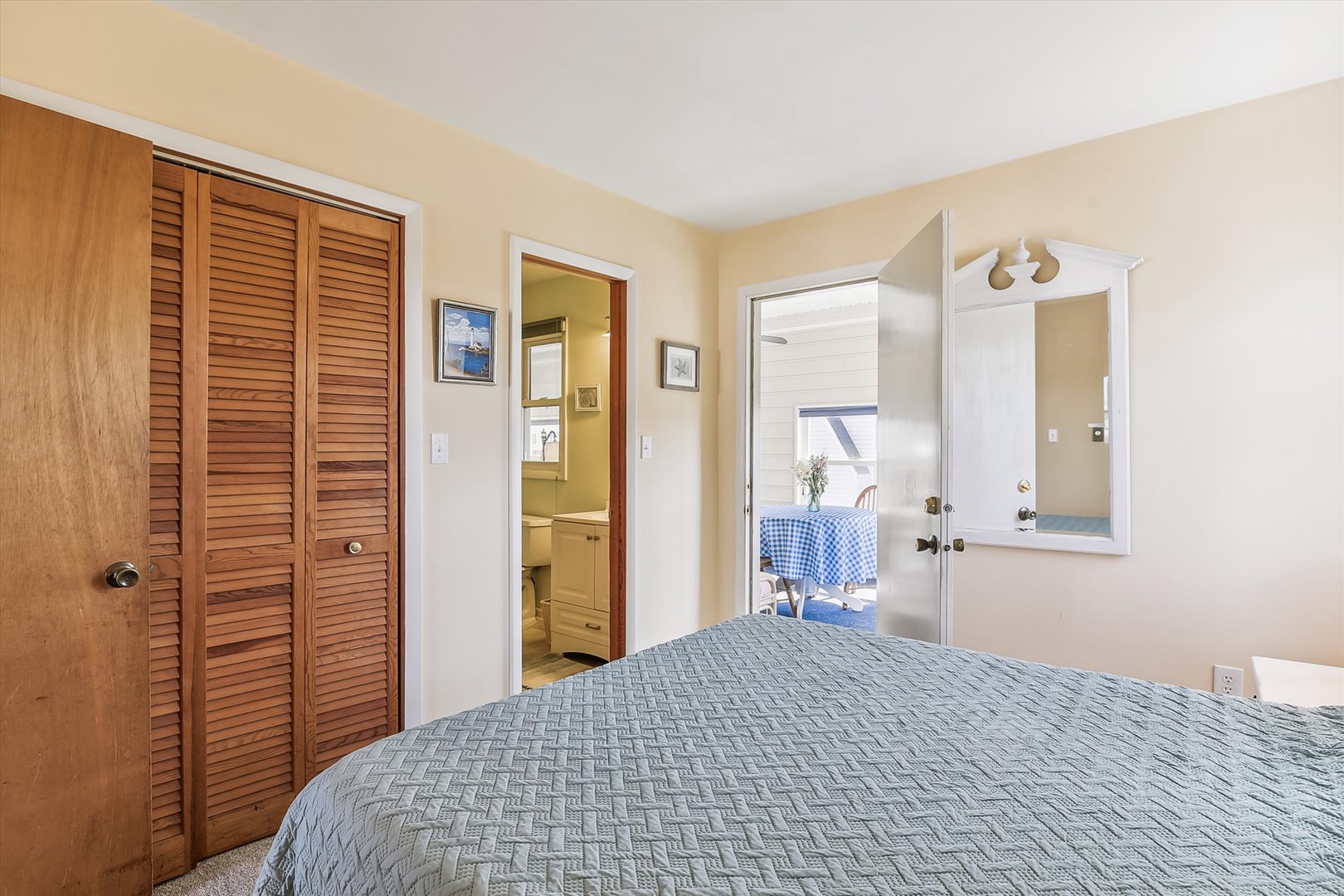 Your peaceful bedroom features a cozy bed, warm natural light, and direct access to a private outdoor dining space—perfect for unwinding after a day of adventure.