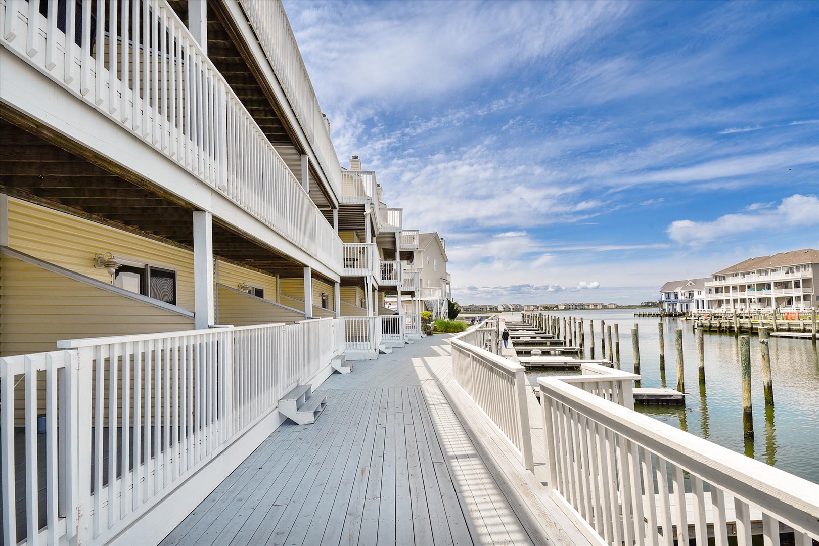 Waterfront property featuring private boat docks and marina access, situated along a peaceful canal with neighboring properties visible across the water.