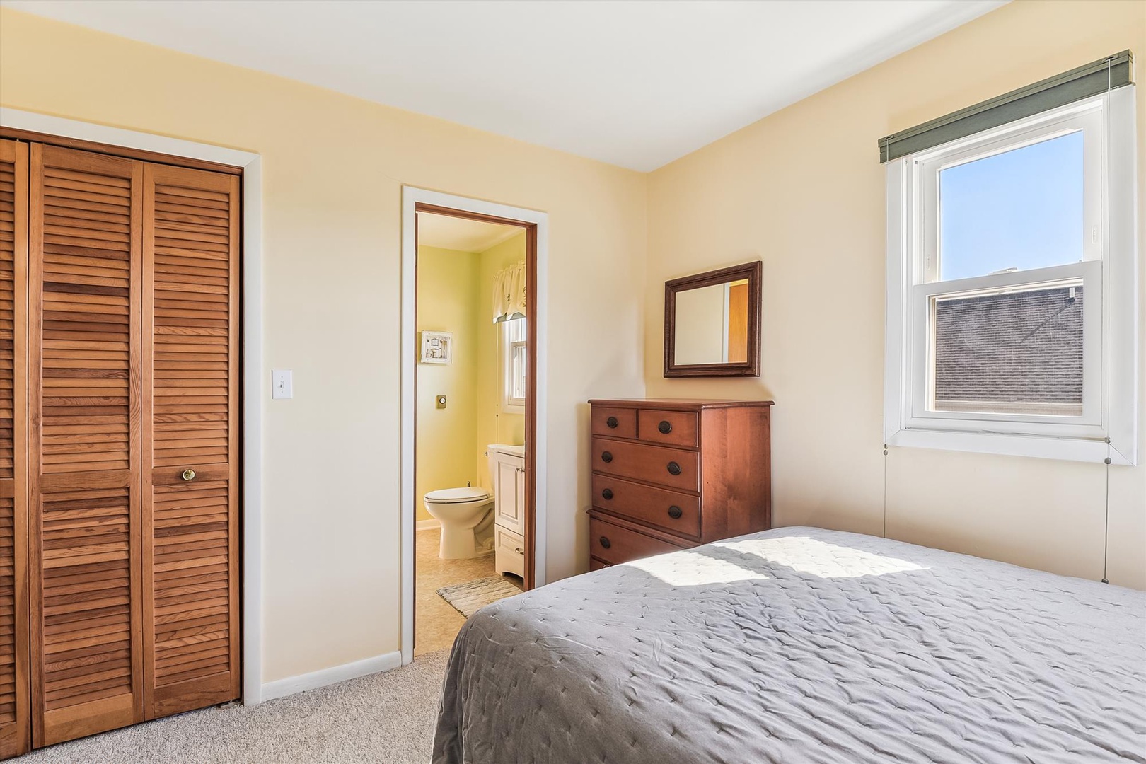 Your cozy bedroom features warm wood tones, an en-suite bathroom, and cheerful natural light—perfect for peaceful mornings and restful nights.