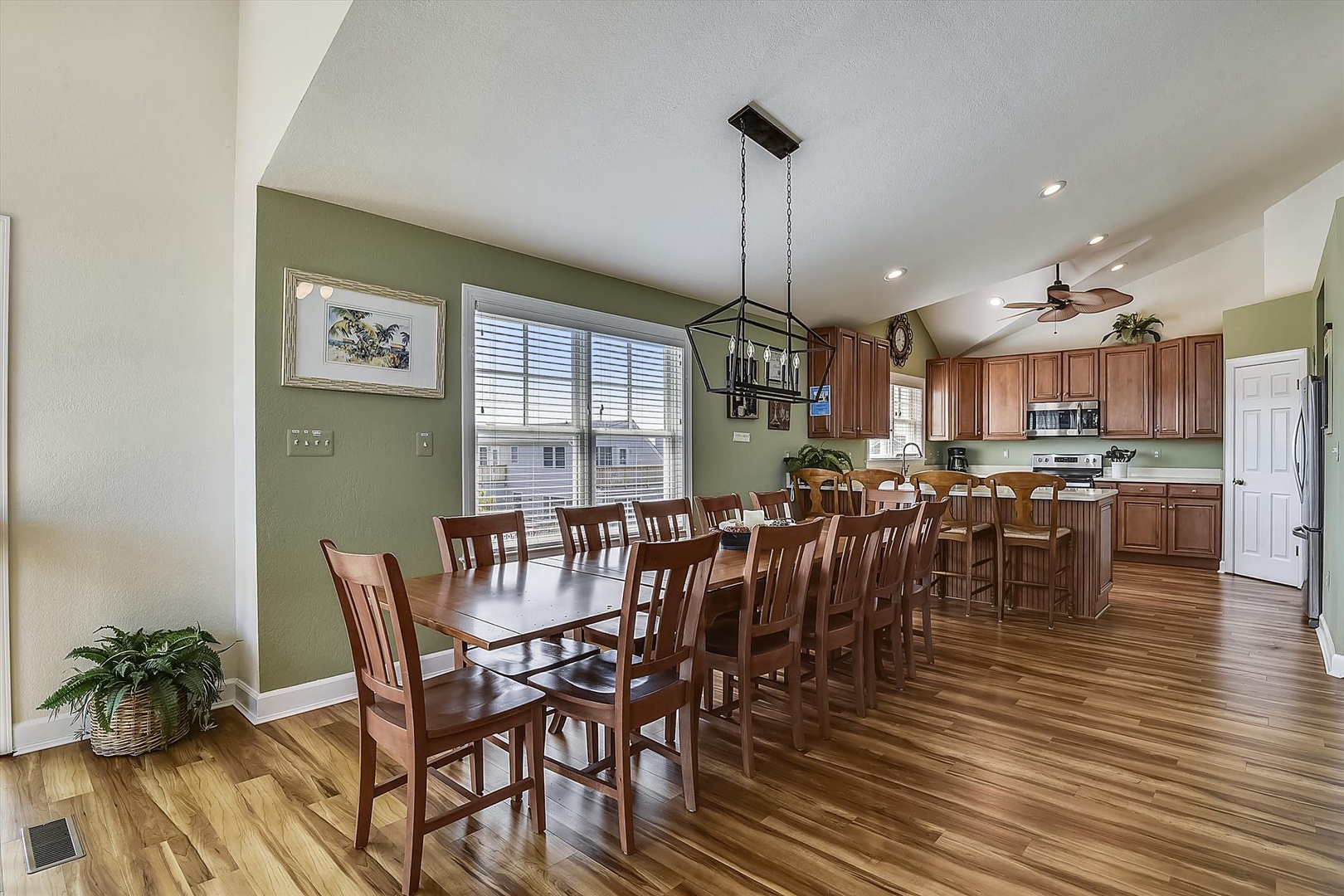 Gather around the spacious dining table with seating for ten, flowing seamlessly into a fully equipped kitchen—perfect for memorable meals and laughter with your group.