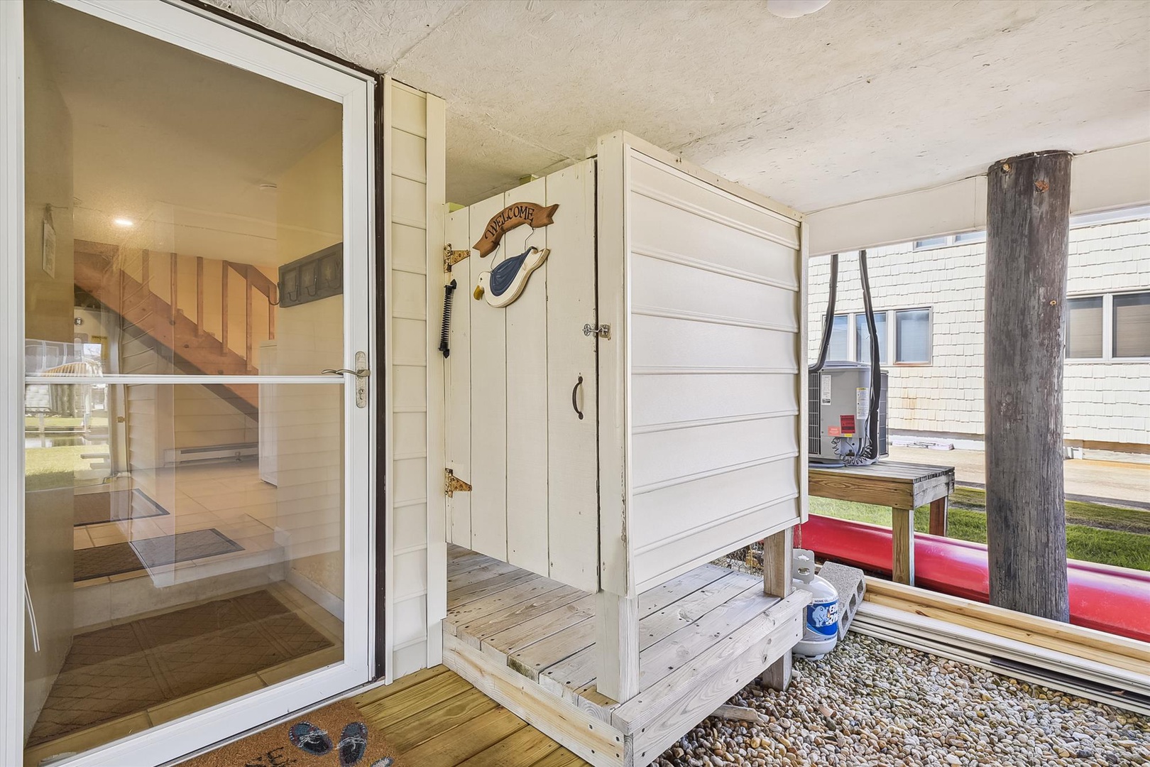 A covered entryway greets you with coastal charm, featuring weathered wood details and nautical decor that set a relaxed, beachy tone for your arrival.