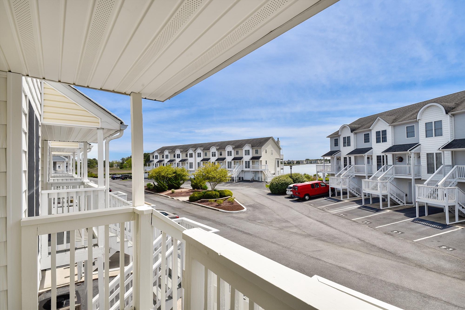A covered balcony overlooks the property's parking area and landscaped courtyard, providing convenient views of the well-maintained grounds below.