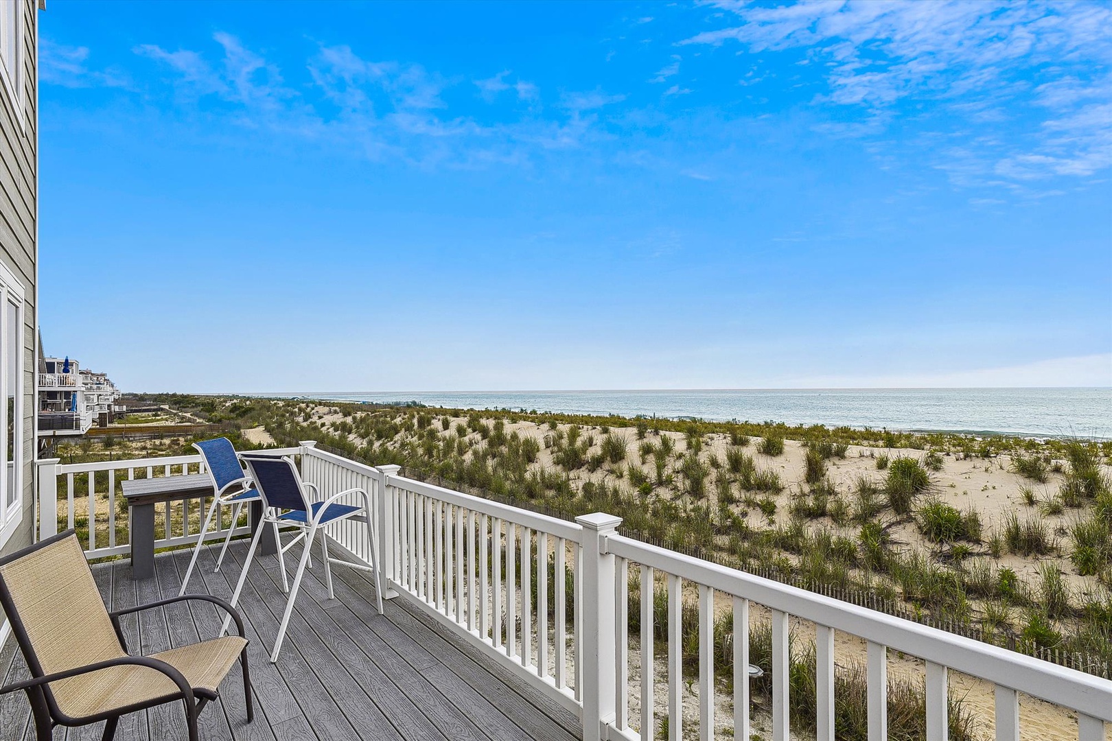 Private oceanfront deck overlooks pristine dunes and endless sea views—the perfect spot to sip morning coffee or watch the waves roll in.
