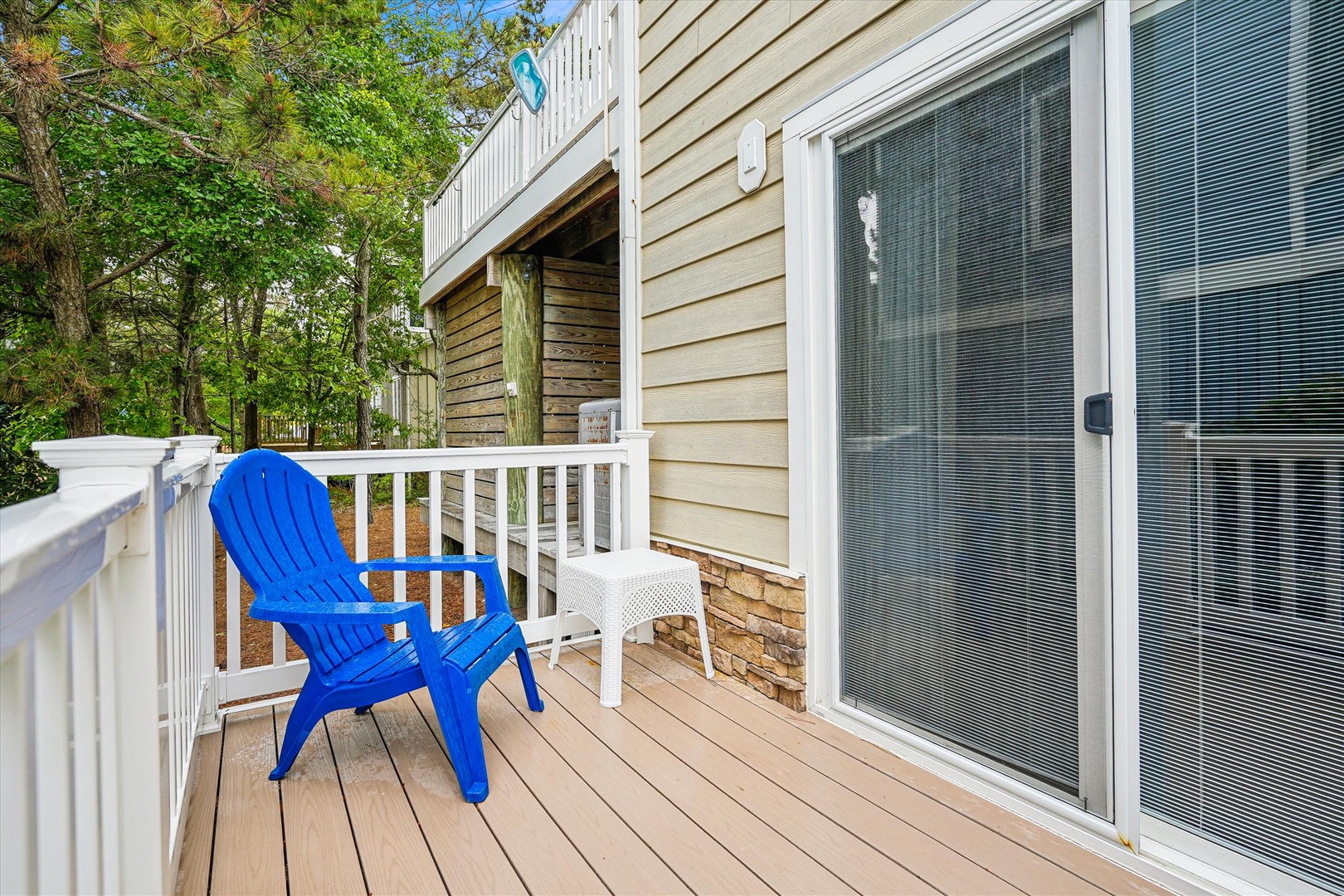 Imagine sipping your morning coffee in this bright blue chair, surrounded by lush greenery and peaceful quiet. Your private deck awaits for relaxing afternoons and refreshing breezes.