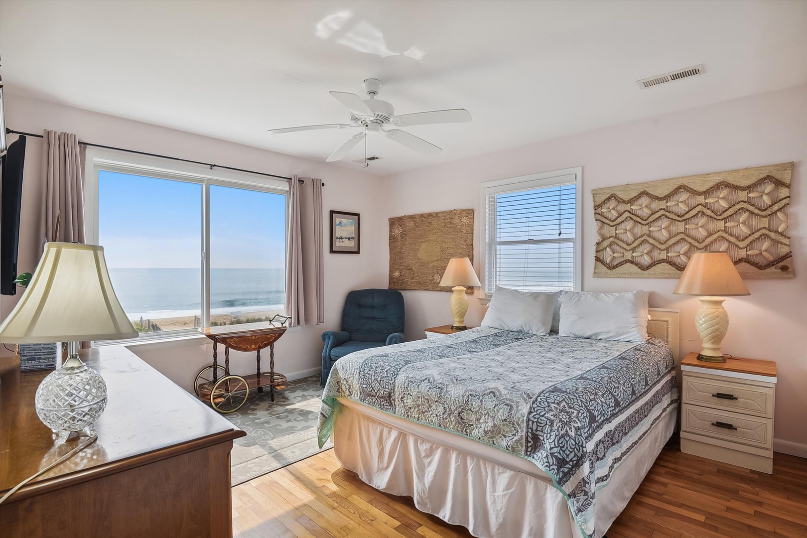 Wake to the sound of waves from this coastal bedroom, with ocean views framing your mornings. The ceiling fan and natural light invite easy relaxation.
