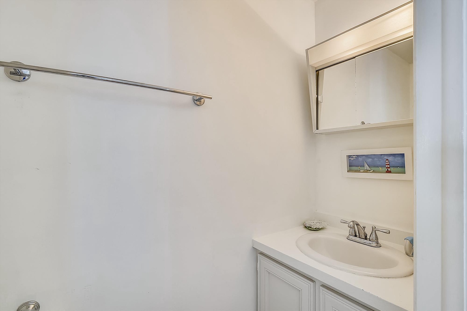 A bright, clean bathroom with a spacious vanity and thoughtful touches, including a mirrored cabinet for all your essentials.
