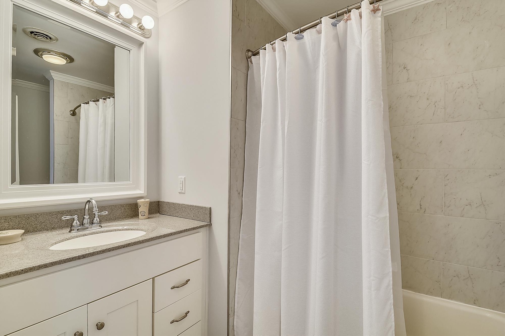 Relax in your pristine marble bathroom with luxury amenities and fresh towels awaiting your arrival.