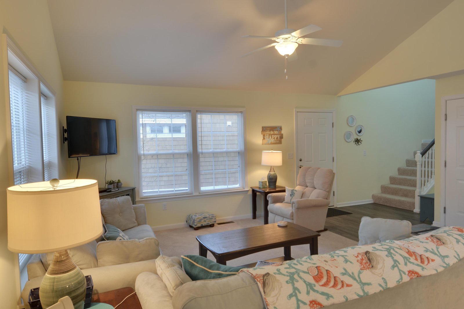 Settle into your cozy living room, where soft lighting, plush seating, and gentle coastal touches invite you to unwind after a day of exploration.