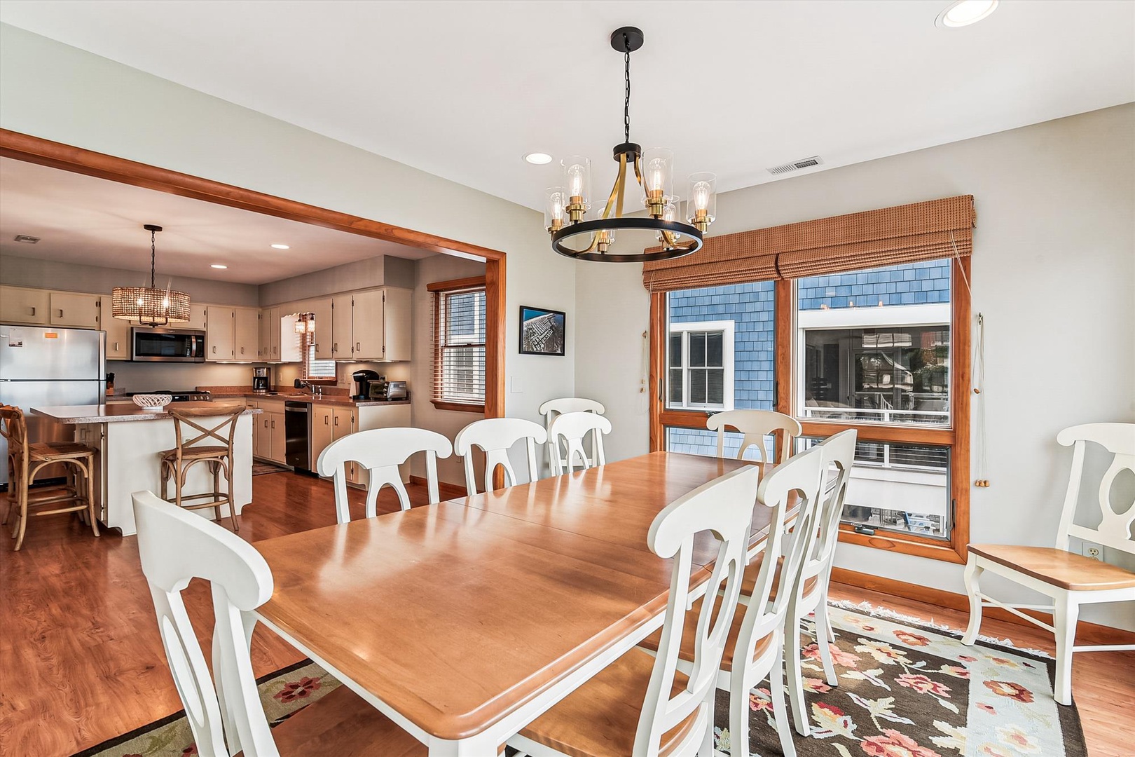 Picture your group gathered around this spacious dining table, sharing meals and making memories. Warm wood tones and abundant natural light create an inviting atmosphere that flows seamlessly into your fully equipped kitchen.