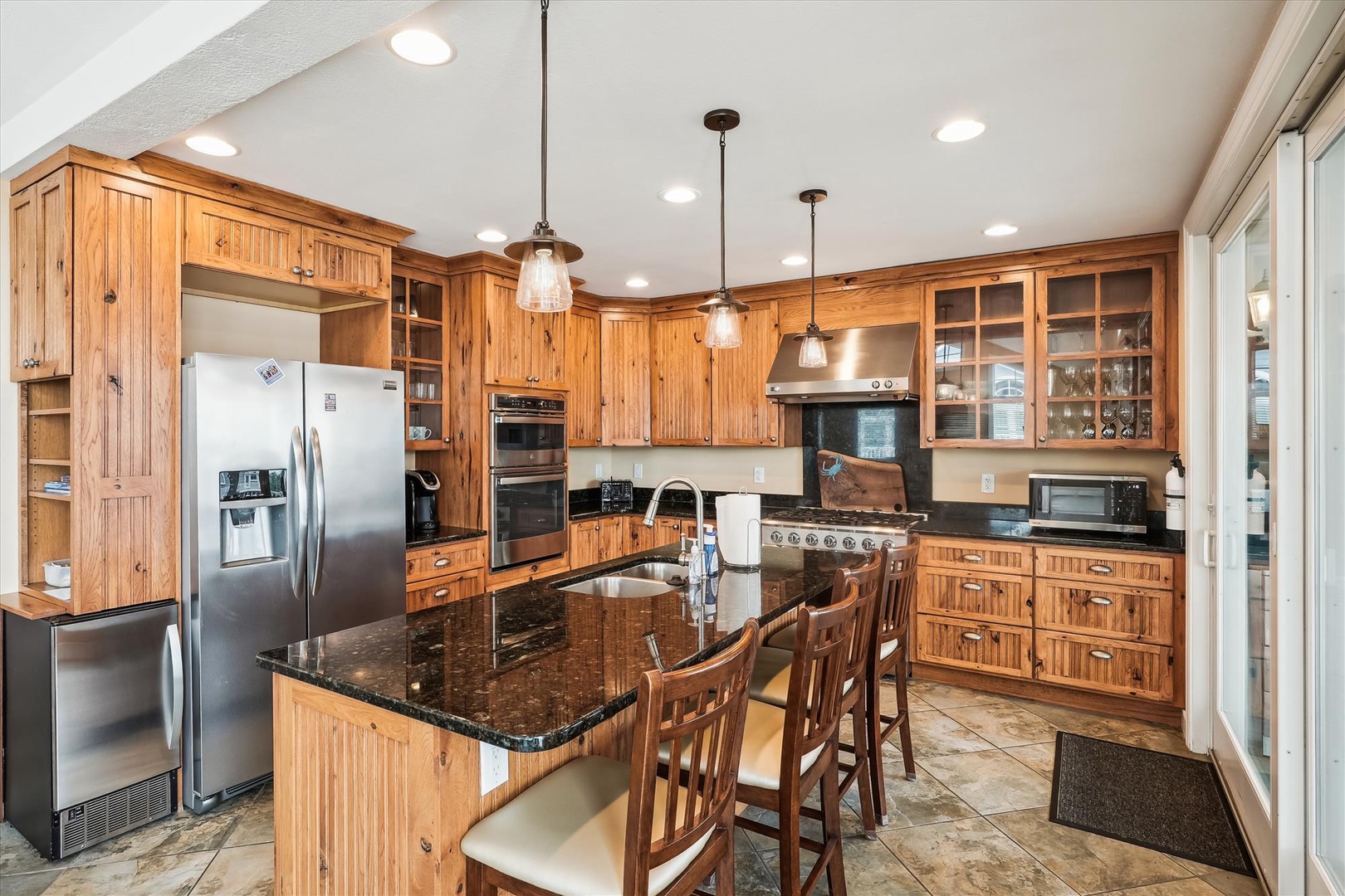 Step into this fully equipped gourmet kitchen where you'll find everything you need to prepare meals in style, from stainless steel appliances to a spacious center island perfect for gathering and cooking together.