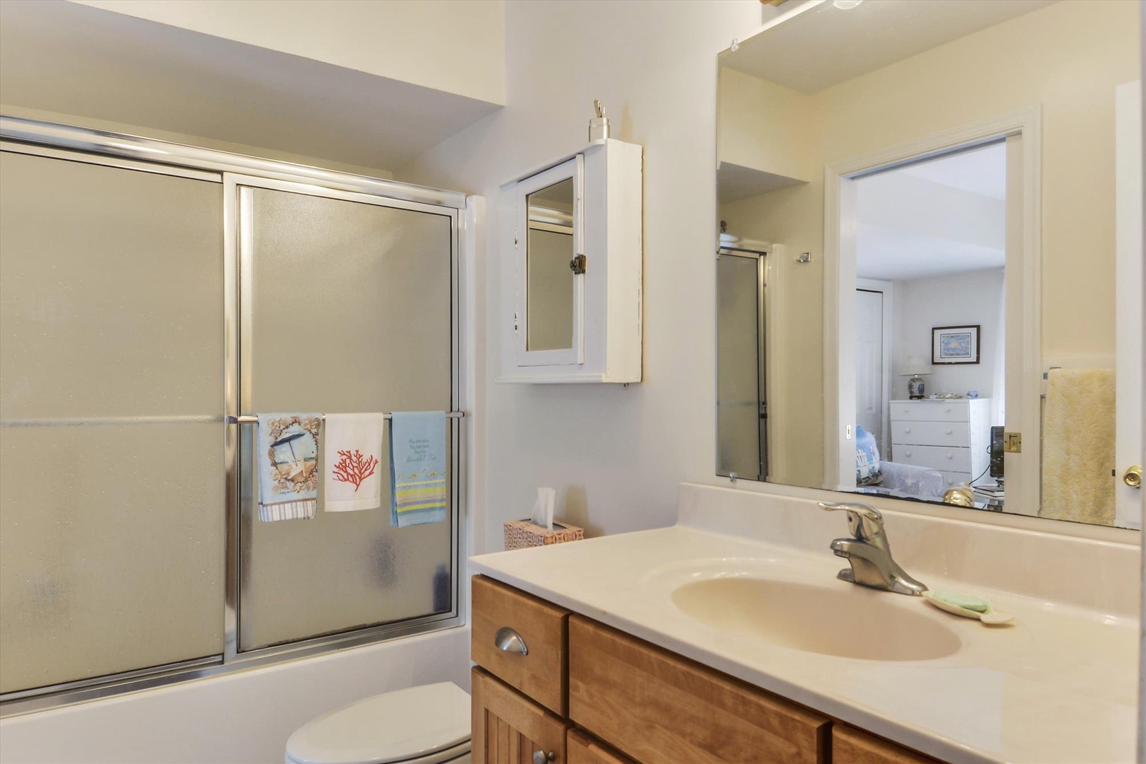 Freshen up in your private bathroom with a spacious vanity, well-lit mirror, and a relaxing tub-shower combo—your coastal retreat's personal sanctuary.