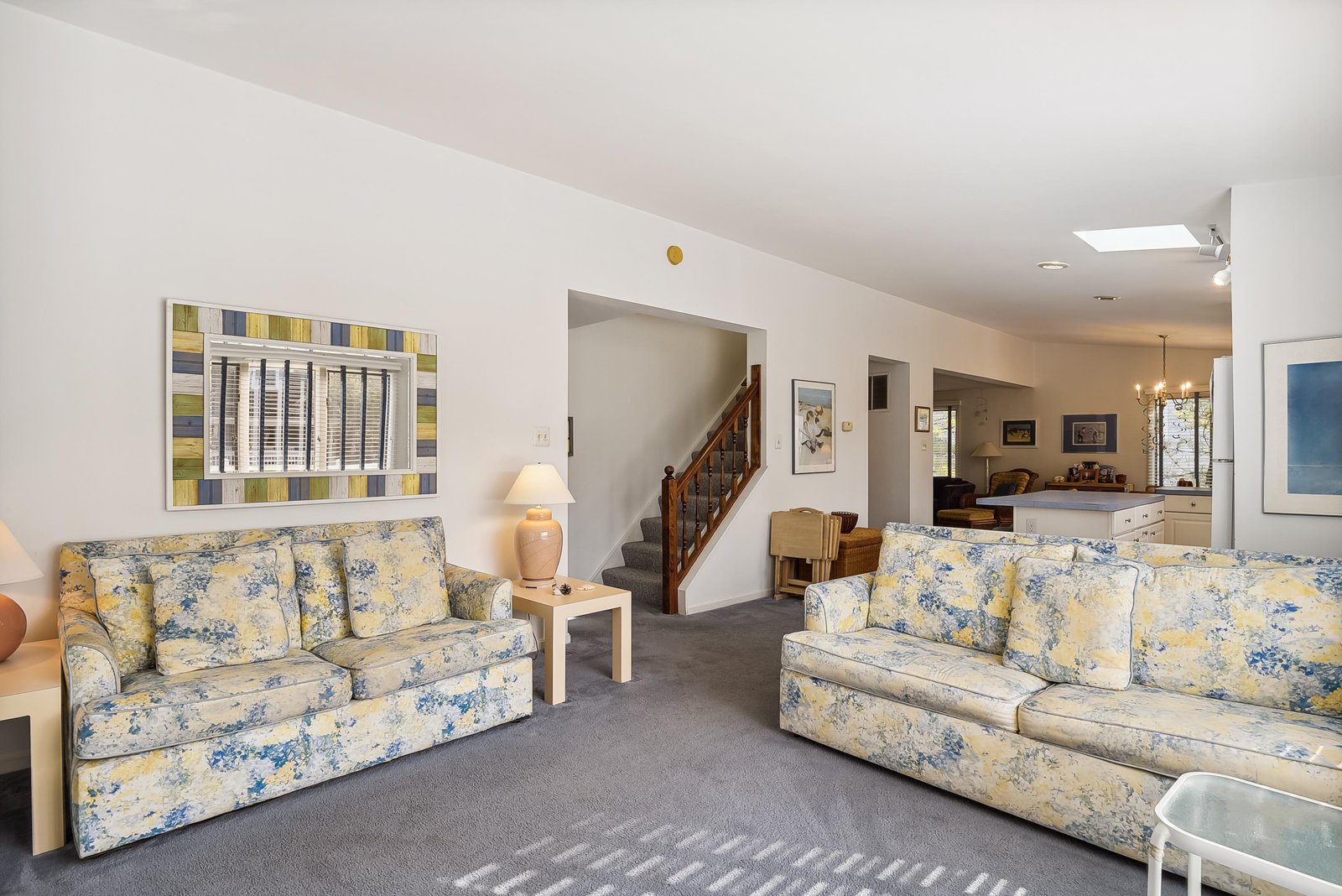 Settle into your spacious living area where two comfortable sofas invite you to relax after a day of adventure. Soft natural light streams through skylights overhead, creating a welcoming retreat.