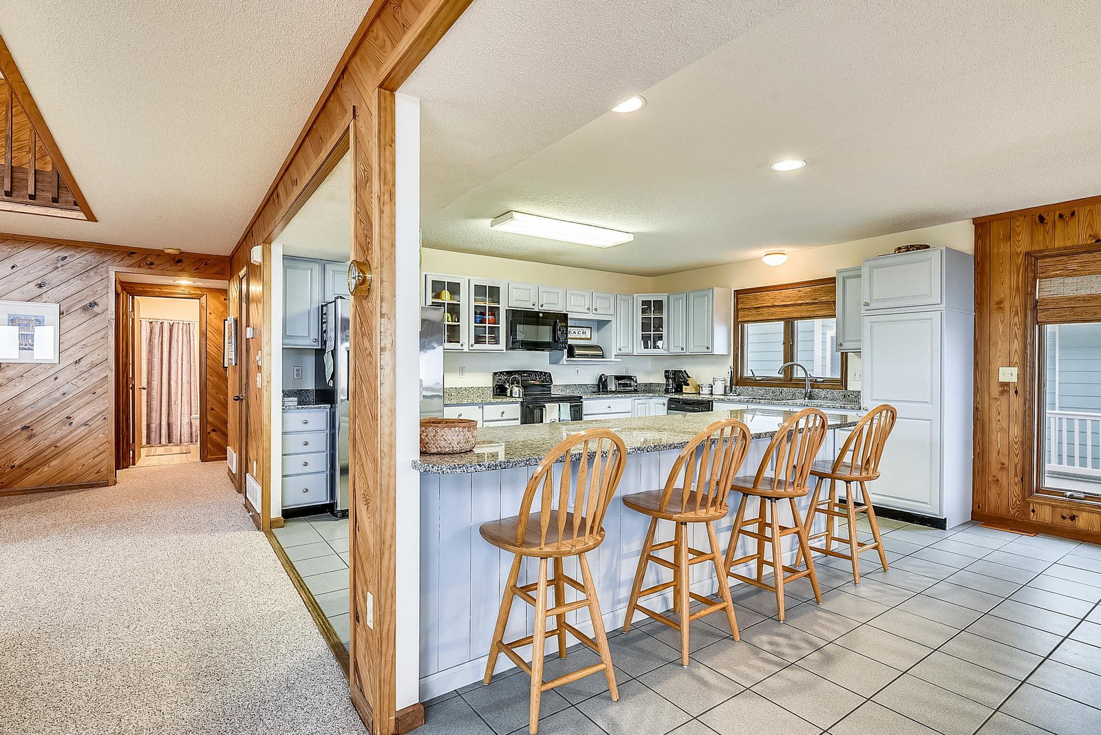 Gather around this spacious kitchen island where your group can share morning coffee and plan the day's adventures together in comfortable style.