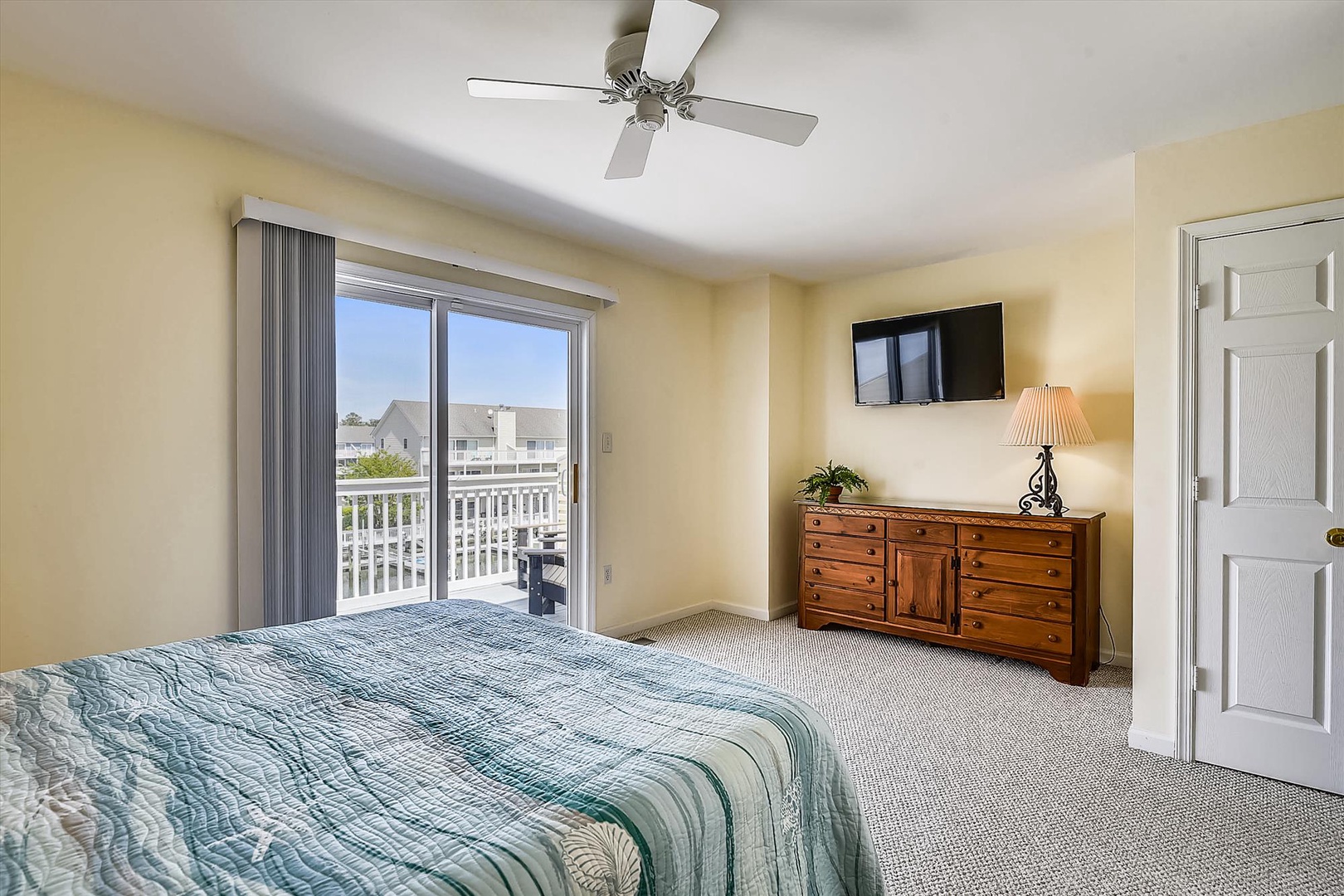 Unwind in your sunlit bedroom with soft coastal tones, a comfy bed, and a private balcony overlooking the neighborhood. Perfect for peaceful mornings or relaxing evenings.