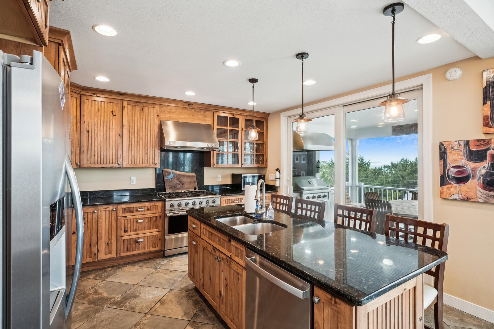 You'll love preparing meals in this bright, fully equipped kitchen with gleaming granite counters, stainless appliances, and a spacious island perfect for gathering around.
