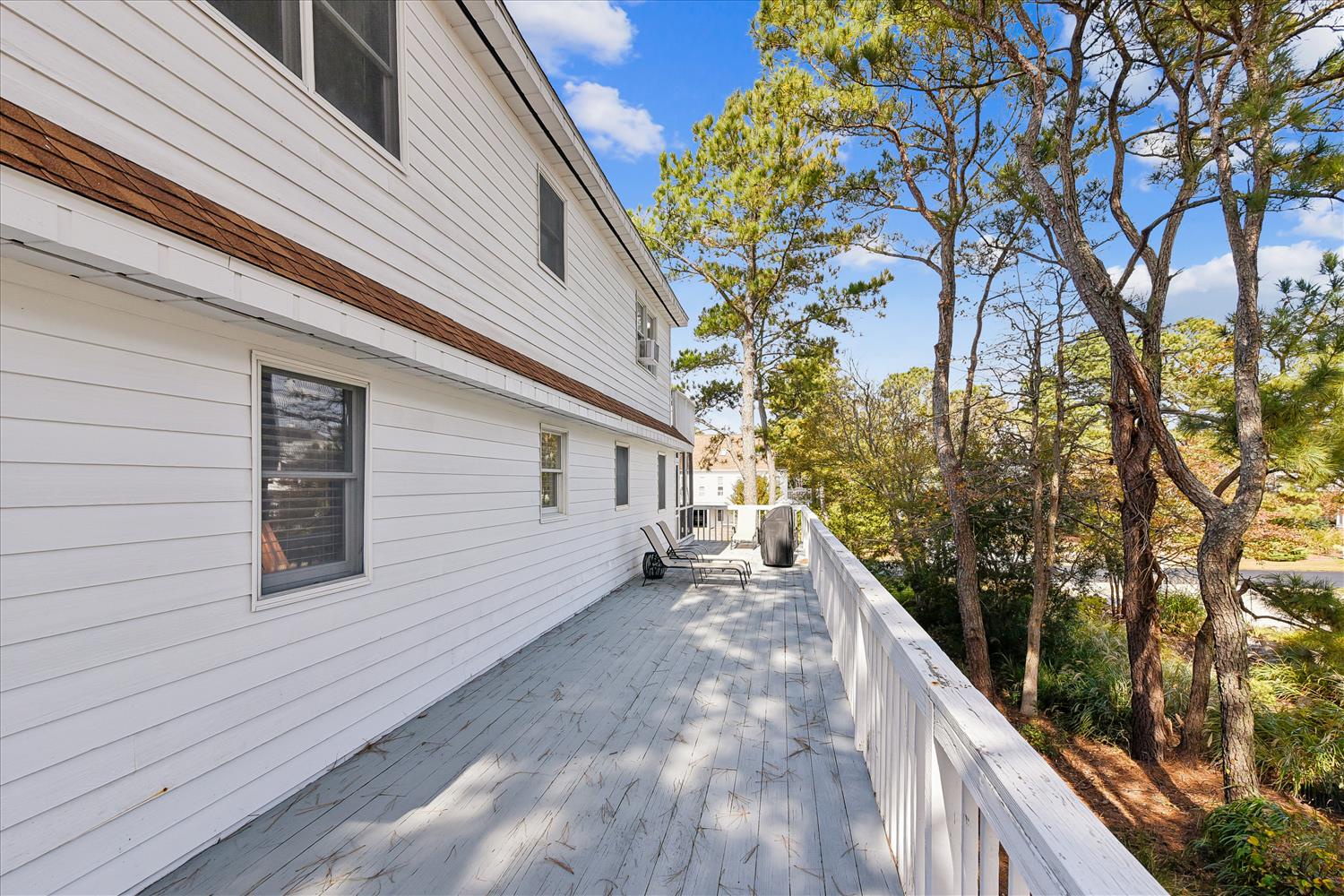 Step onto your private deck surrounded by mature trees, where morning coffee feels magical amid nature's peaceful canopy.