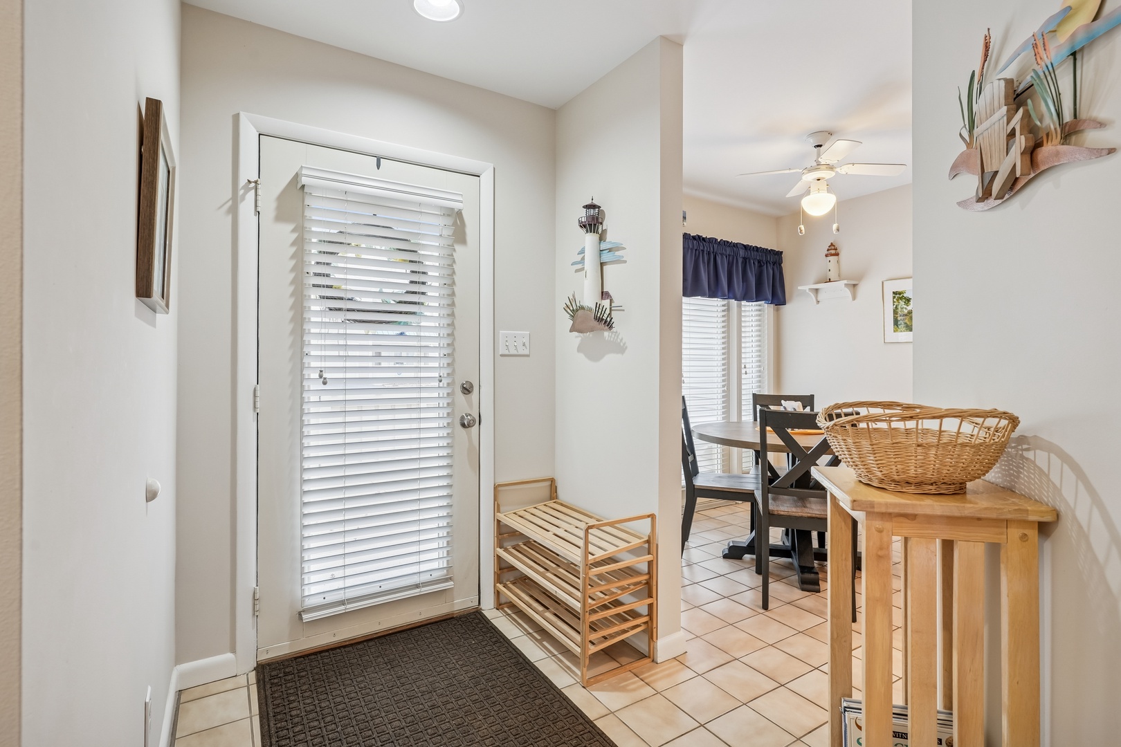 Step into your welcoming entryway where coastal charm meets comfort—complete with convenient shoe storage and easy access to your dining space.