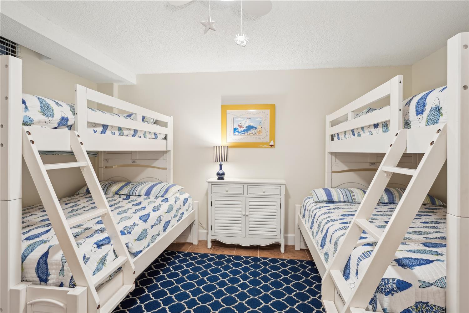 A cheerful coastal-themed bunk room where your family can rest after beach adventures. Nautical accents and playful fish motifs create a fun, relaxed atmosphere for restful nights.