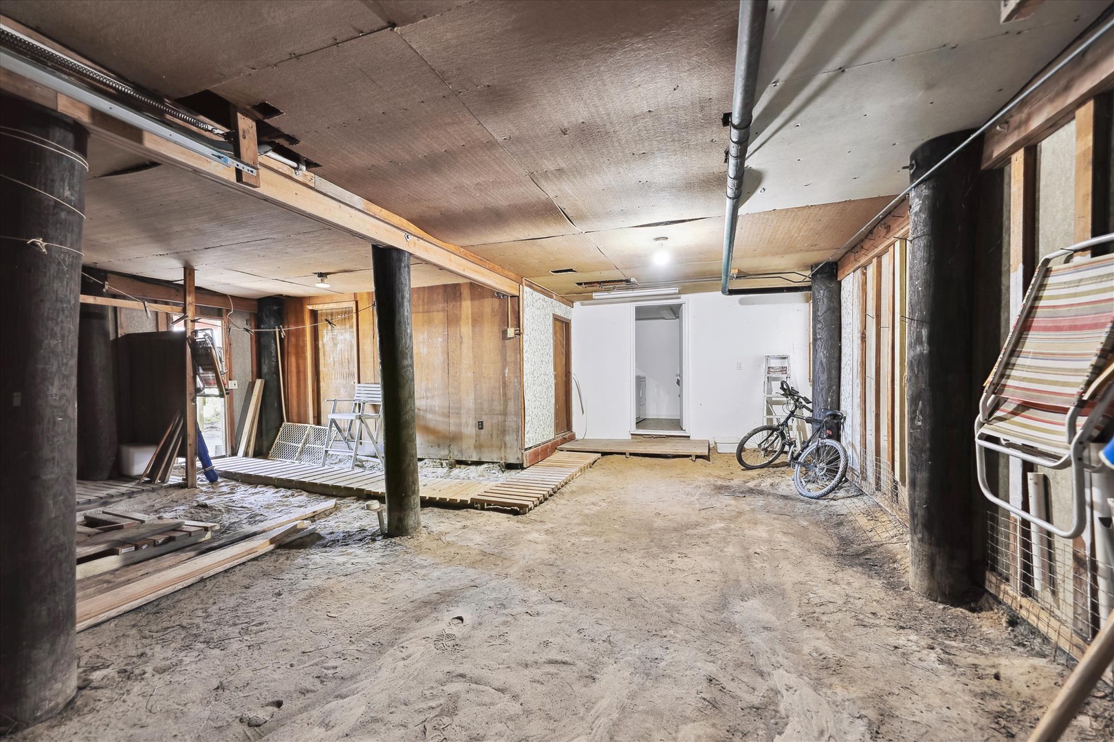 Secure underground storage and parking area beneath the property, featuring spacious covered access and room for bicycles or seasonal equipment.