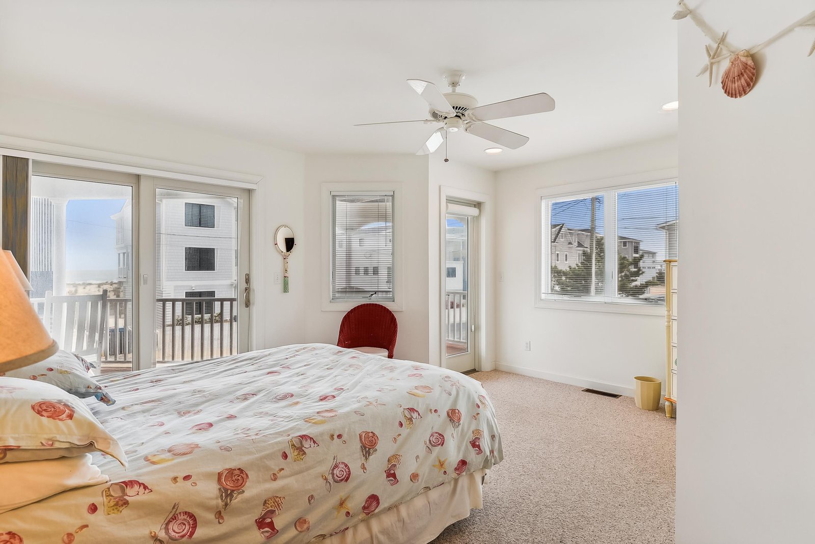 Your bright coastal bedroom features a ceiling fan for comfort and sliding doors that open to your private balcony, with soft natural light filling the space throughout the day.