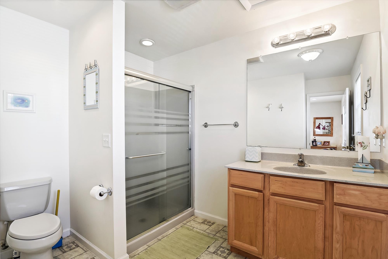 Your private bathroom features a walk-in shower, spacious vanity with ample storage, and bright lighting to start your day refreshed.