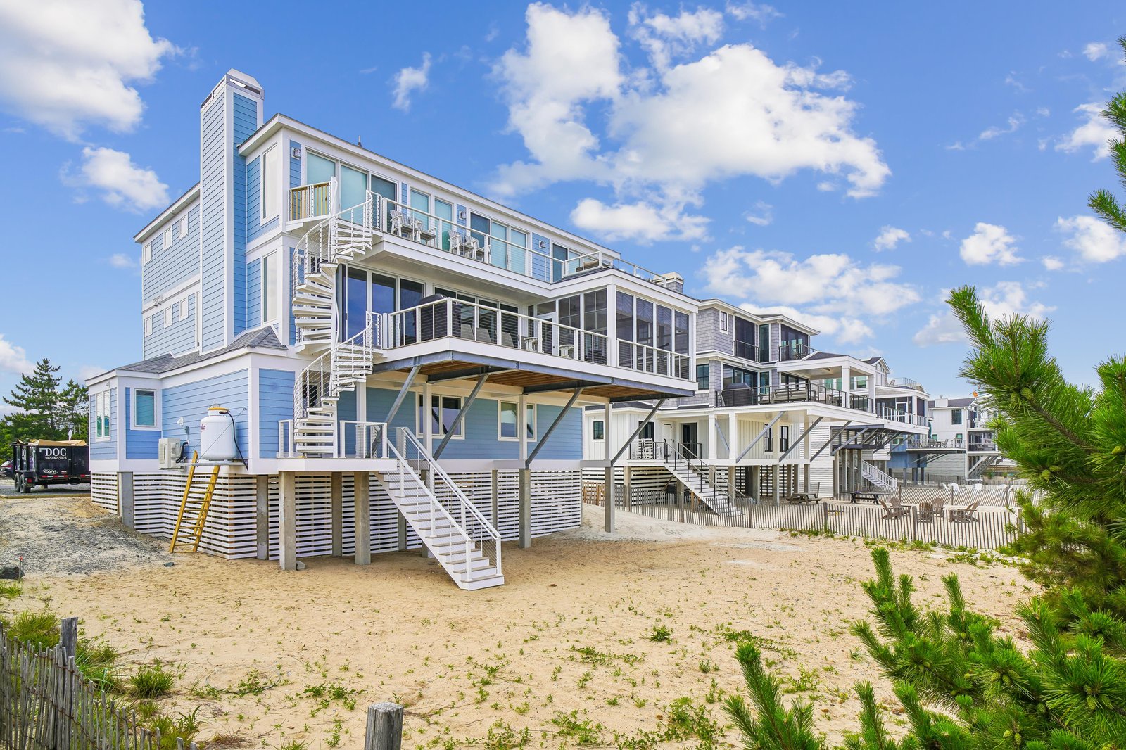 This stunning beachfront property sits directly on the sand with expansive decks and balconies perfect for watching the waves. The multi-level design offers generous outdoor spaces and unobstructed coastal beauty.
