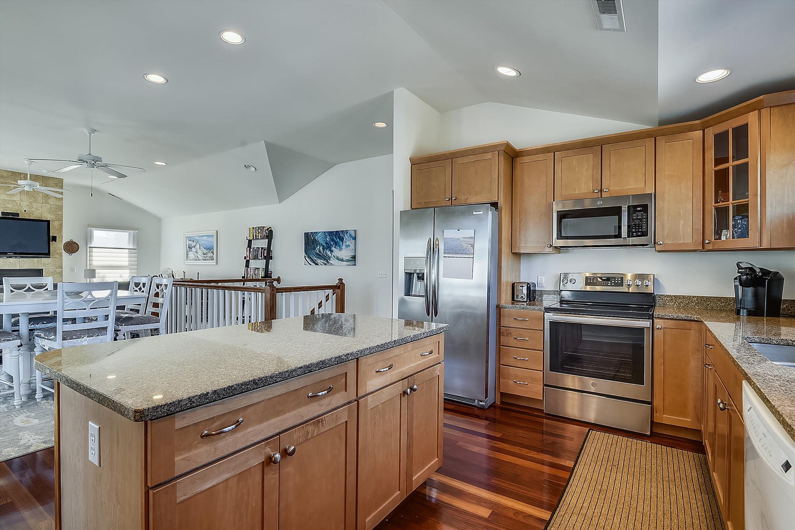 Your spacious, chef-ready kitchen features rich wood cabinetry, granite countertops, stainless steel appliances, and a generous island—perfect for preparing memorable vacation meals together.