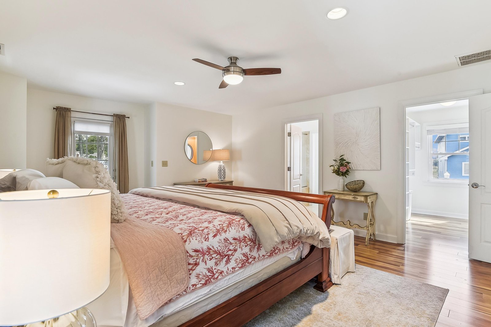 Settle into your peaceful retreat with soft linens, warm wood tones, and a ceiling fan to keep you comfortable all year long.