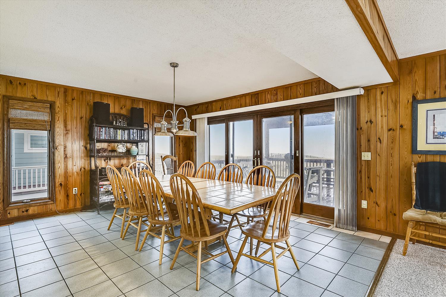 Gather everyone around this welcoming dining table, where warm wood tones and plenty of natural light create the perfect spot for your group meals and memorable conversations.