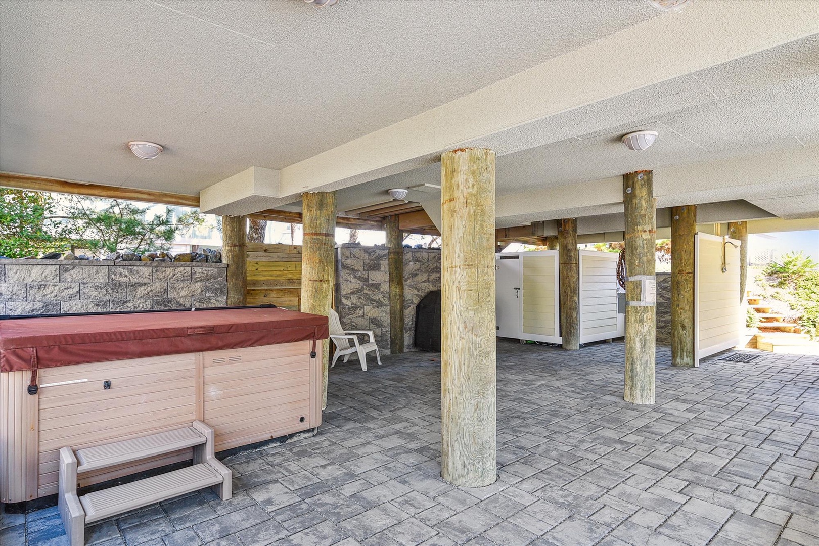 Slip into your private hot tub after a day of exploring, then gather under the covered patio for relaxed evenings surrounded by natural stone accents and tropical greenery.