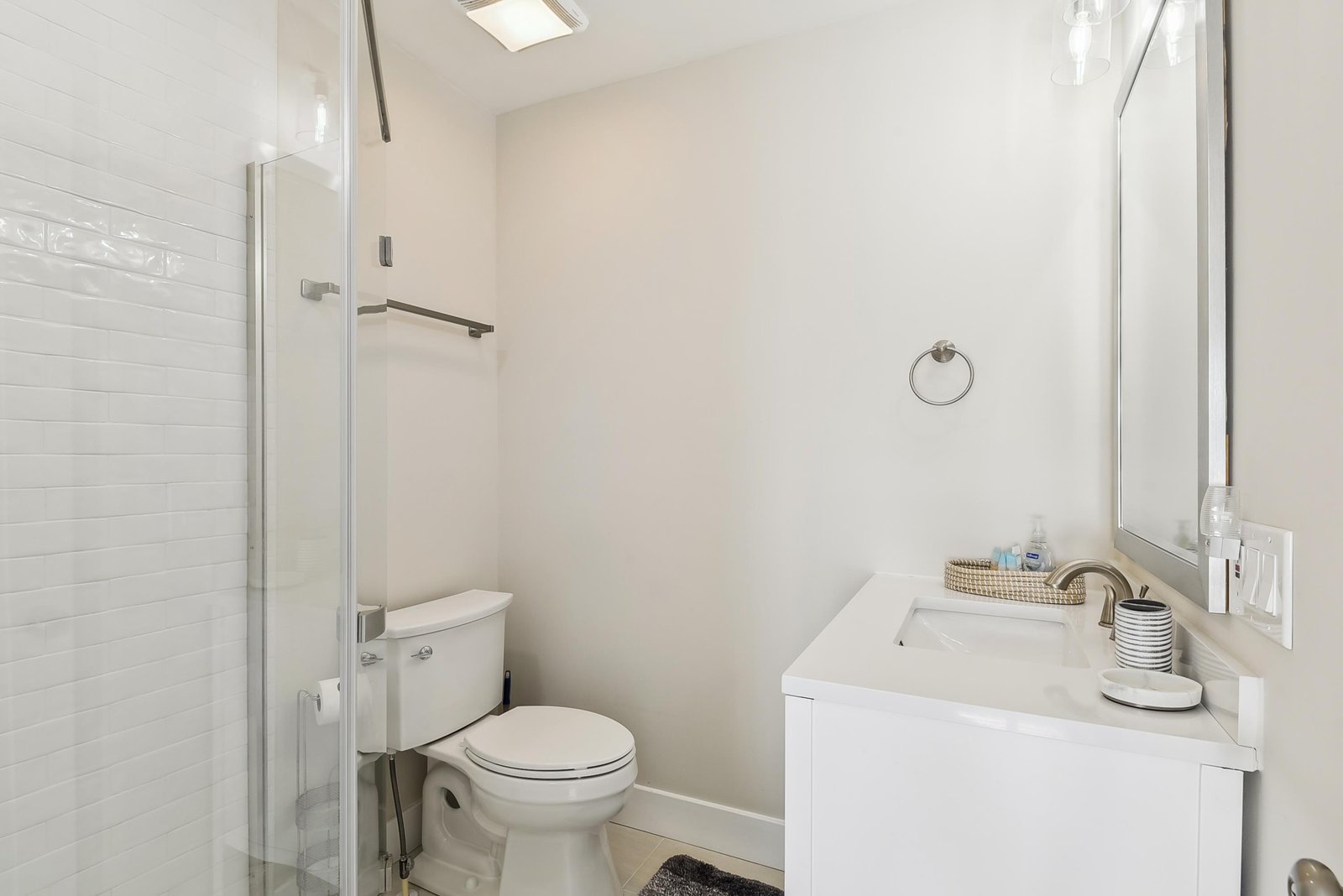 Your private bathroom feels fresh and inviting with its bright, clean design. Natural light from the skylight enhances the crisp white finishes, creating a serene space to refresh after a day of exploring.