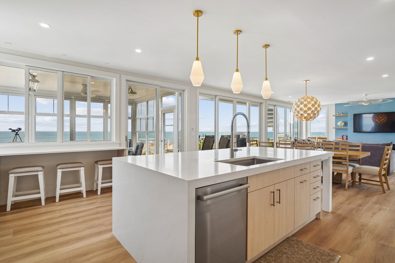 Step into your bright, open kitchen where sleek countertops and modern appliances meet breathtaking ocean views through expansive windows—your perfect space for morning coffee or preparing coastal-inspired meals.