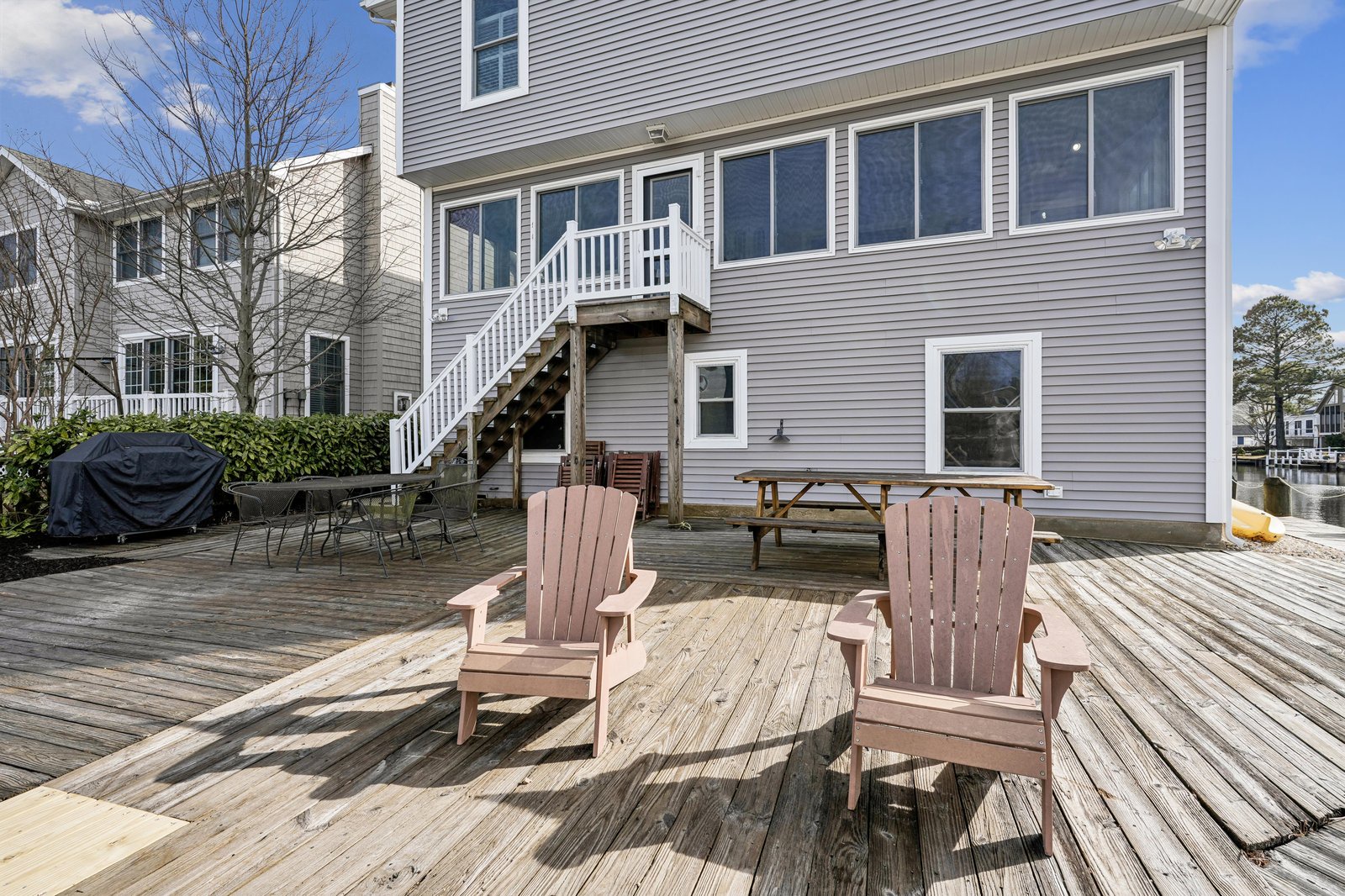 Your private waterfront deck awaits with roomy Adirondack chairs, picnic seating, and a grill perfect for warm evenings. Relax, dine alfresco, and soak up peaceful views.