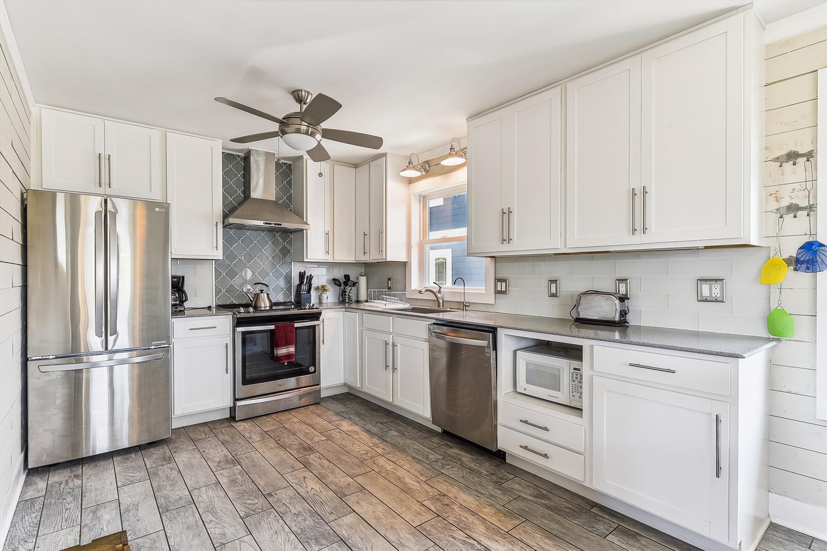 Your fully equipped kitchen features modern appliances, ample counter space, and bright white cabinetry—perfect for preparing meals or enjoying morning coffee in comfort.