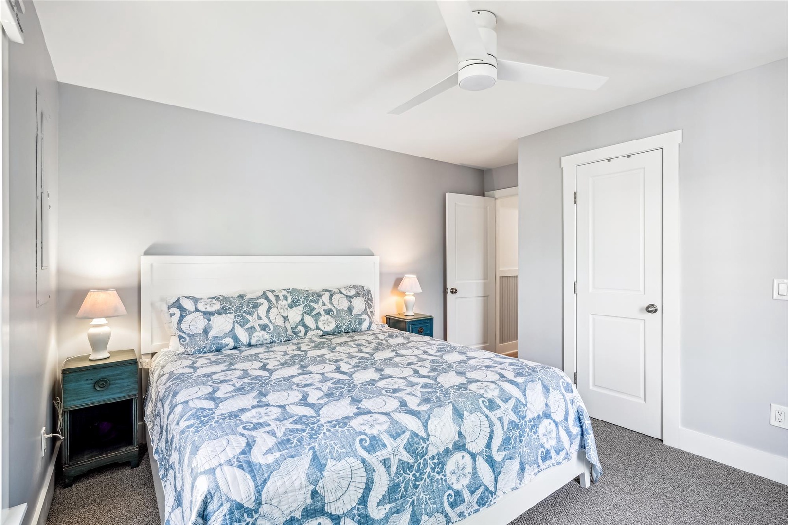 Drift off in your serene bedroom with coastal-inspired linens, soft bedside lighting, and a gentle ceiling fan creating the perfect sleep sanctuary.