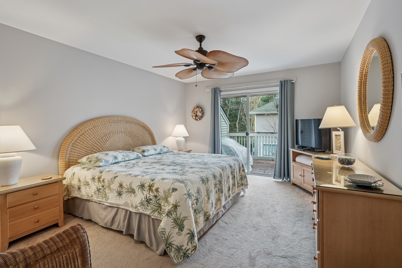 Drift into peaceful sleep in your coastal-inspired bedroom with tropical bedding and private balcony access overlooking serene surroundings.