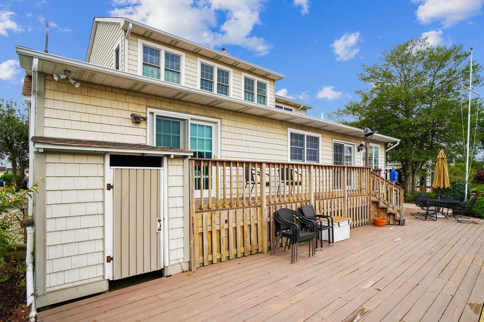 A spacious two-story property with generous outdoor deck space, perfect for relaxing under open skies and gathering with loved ones throughout your stay.