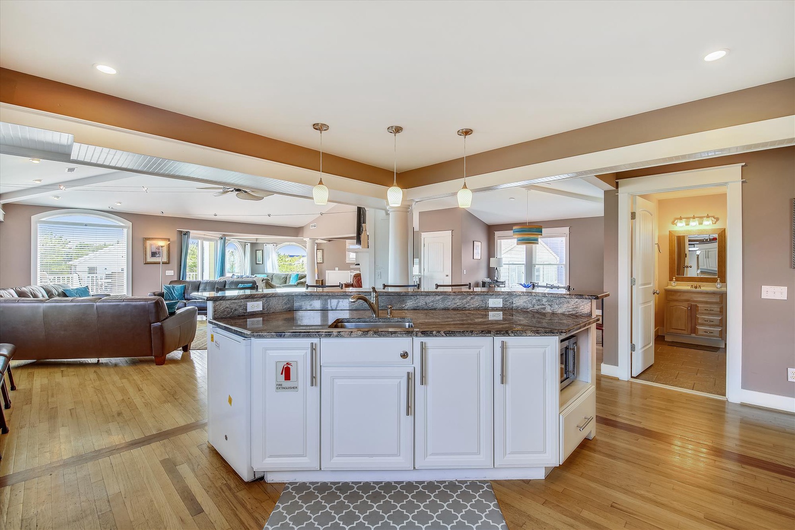 Step into a spacious, open-concept retreat where your vacation unfolds seamlessly between kitchen, dining, and living areas—bathed in natural light and designed for effortless entertaining.