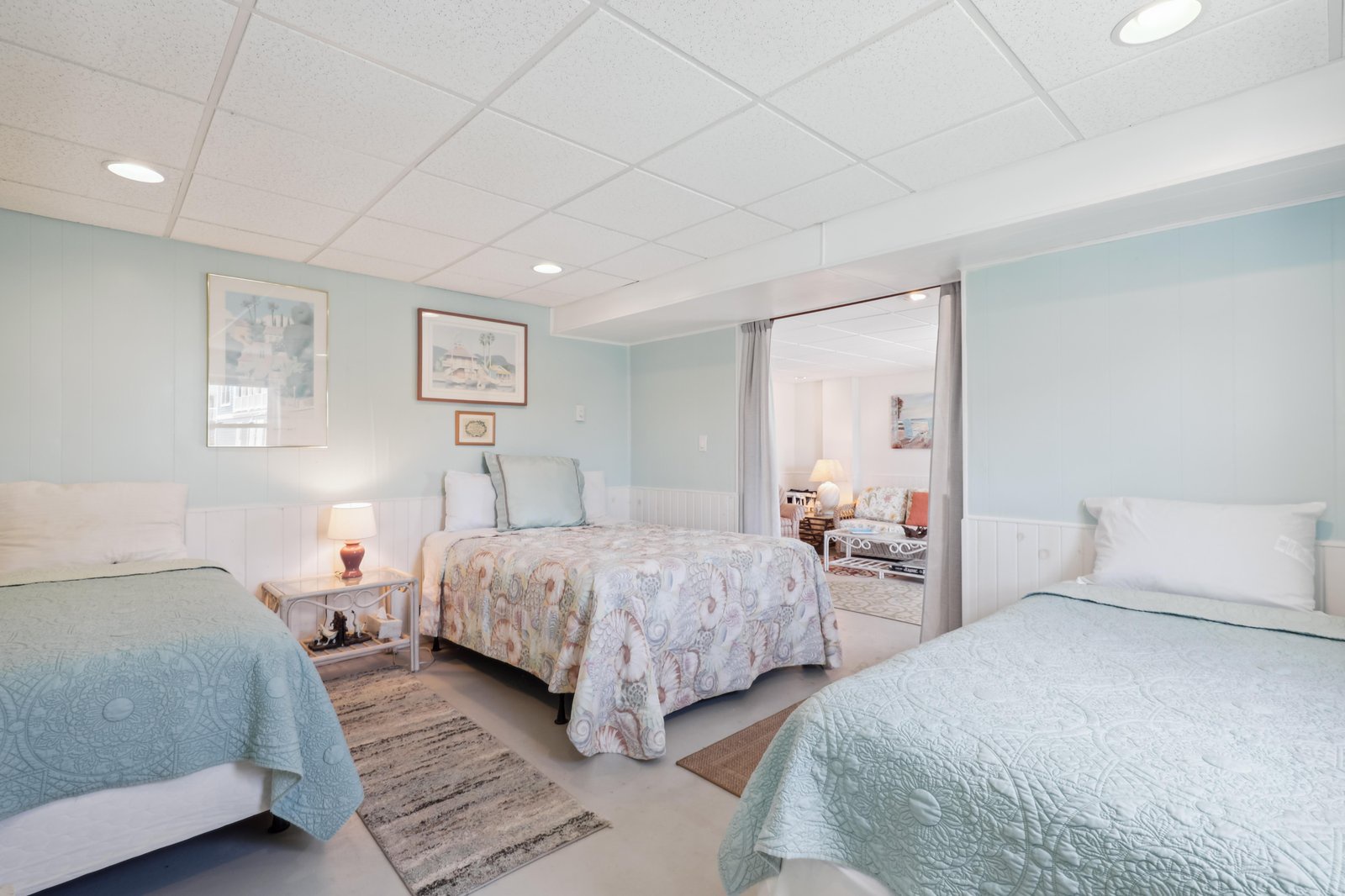 Settle into your peaceful coastal bedroom, where soft seafoam hues and crisp linens create a serene retreat after a day of seaside adventures.
