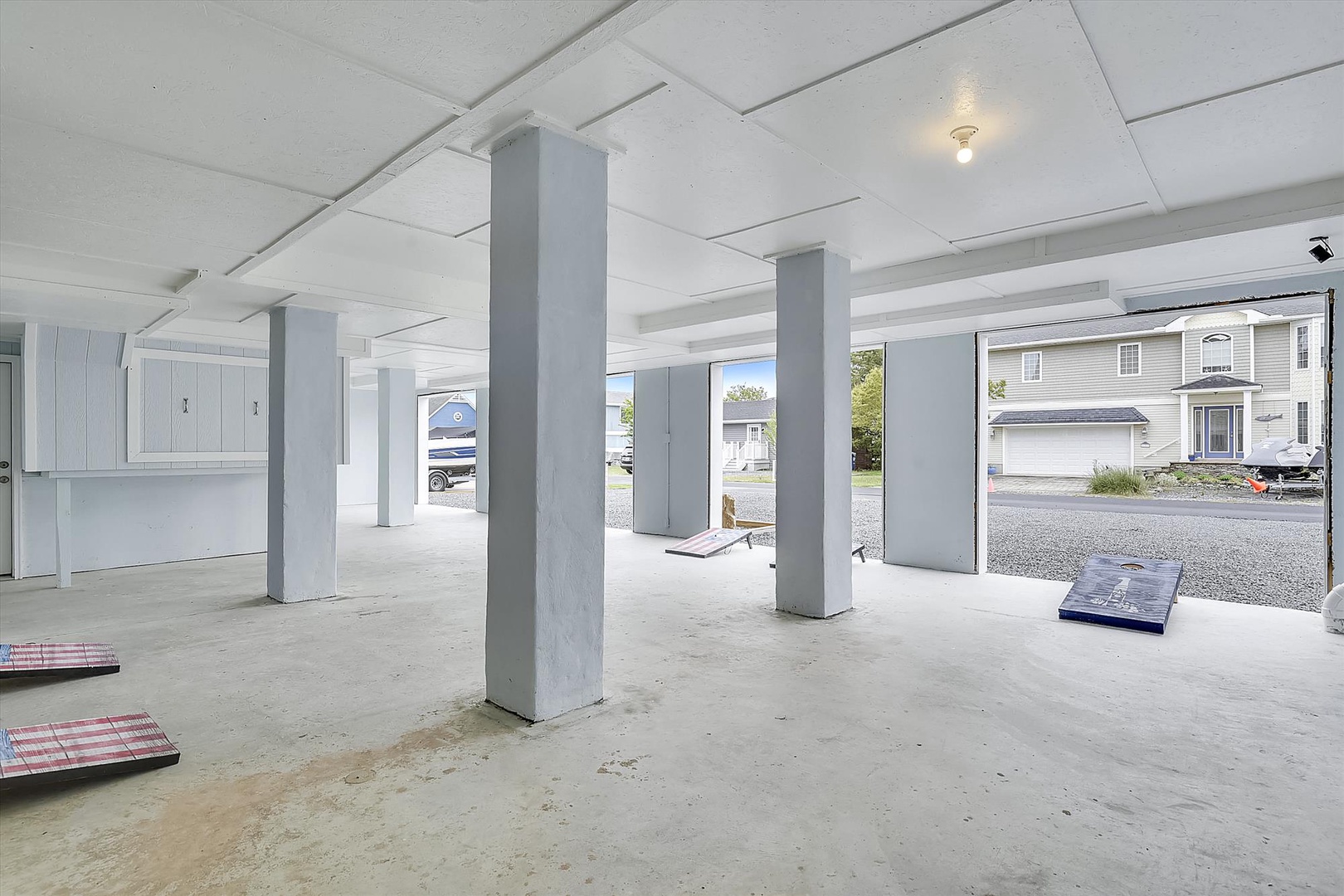 Ground-level parking with secure storage cabinets and covered access, offering protection from the elements and convenient space for vehicles and gear.